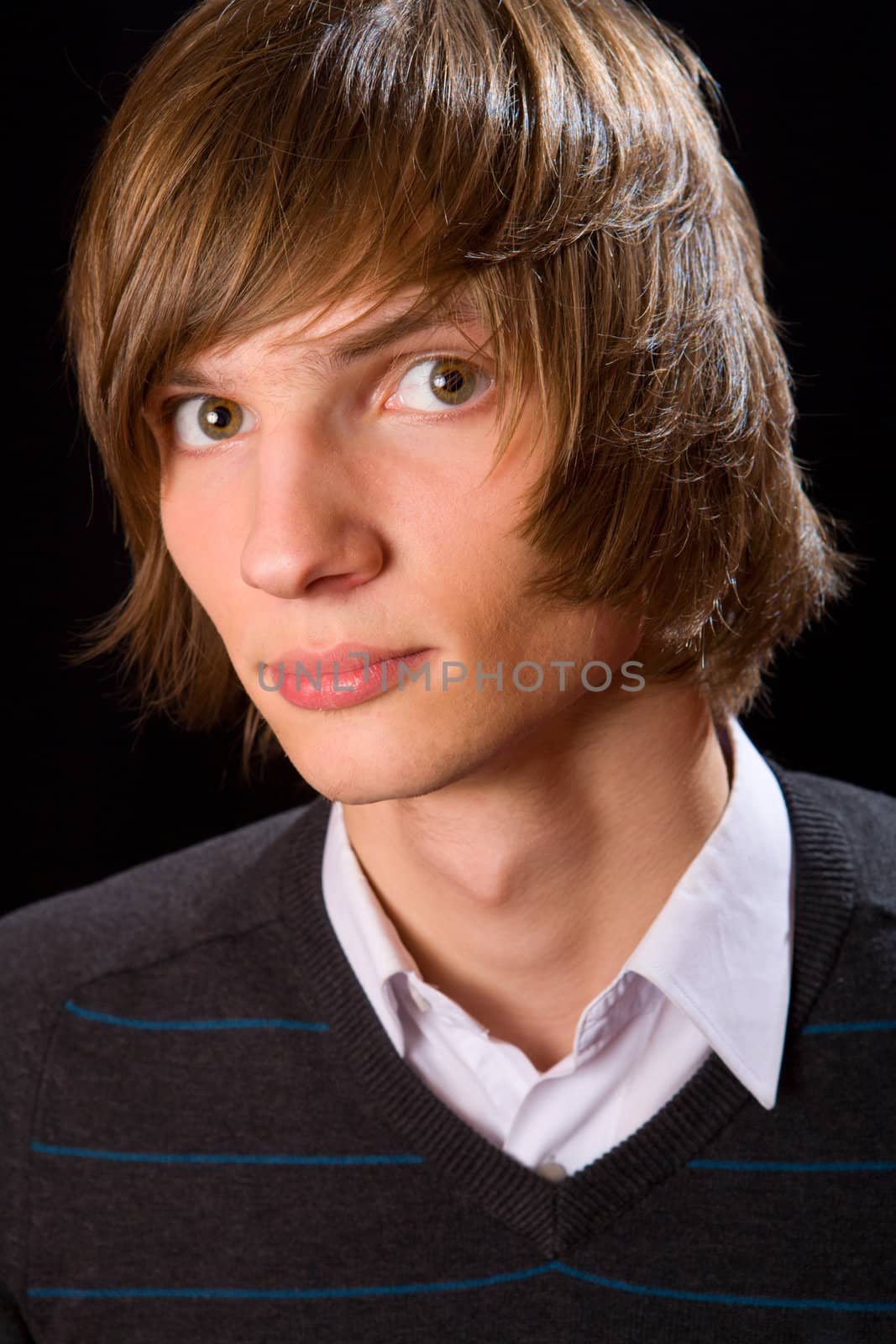 Young serious man over black background