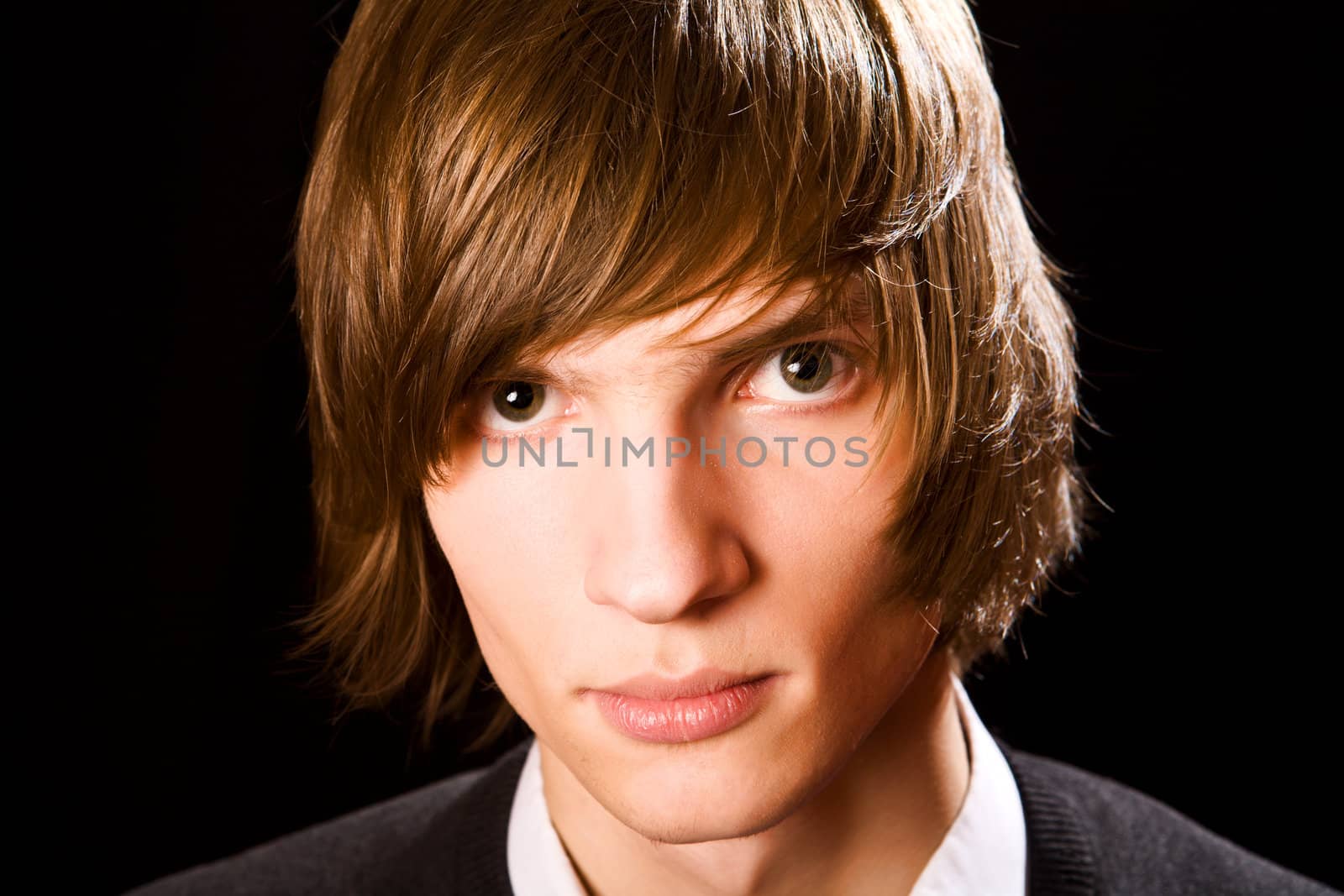Young serious man over black background