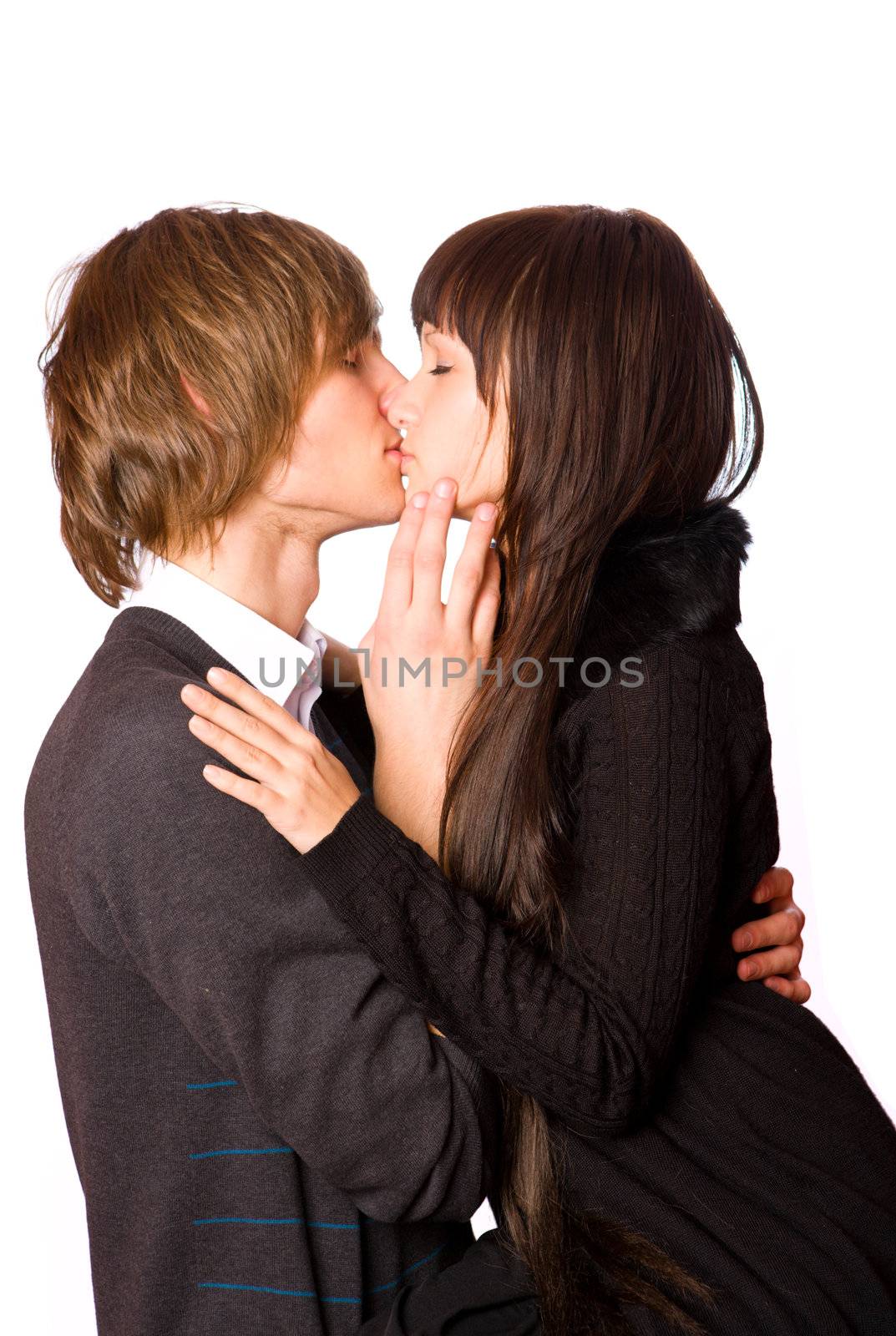 Young beautiful couple kissing isolated on white