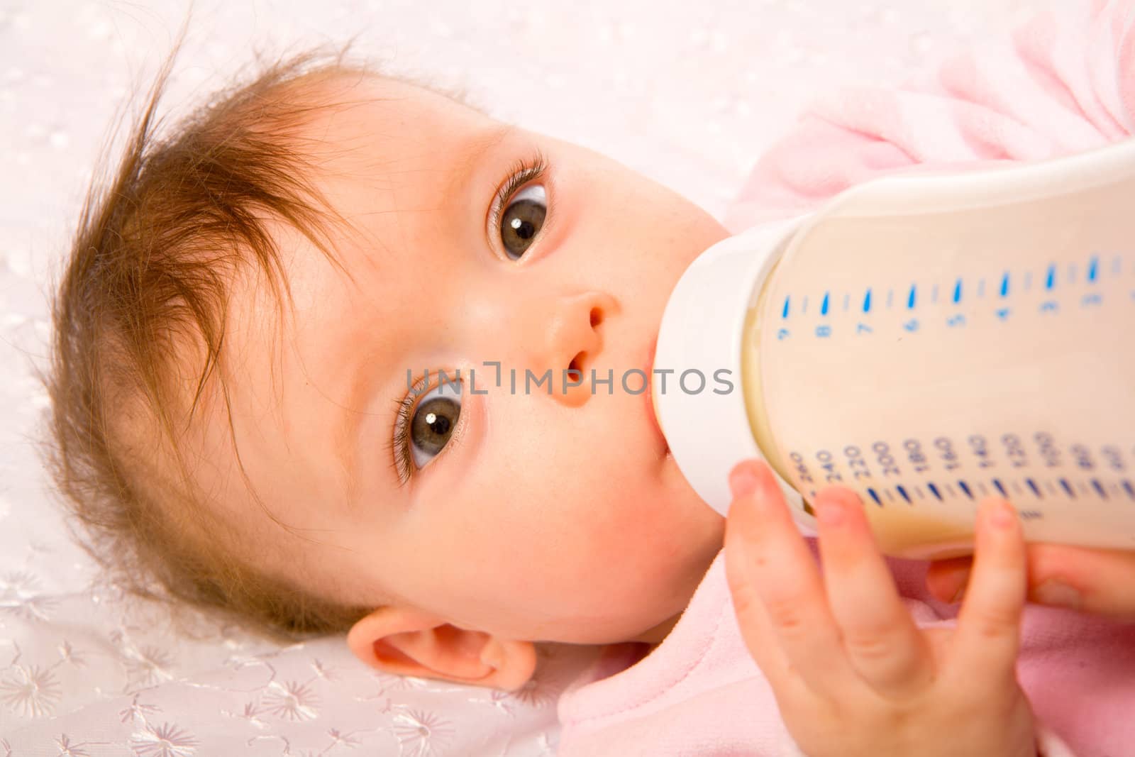 Adorable Seven month Baby eating from bottle 