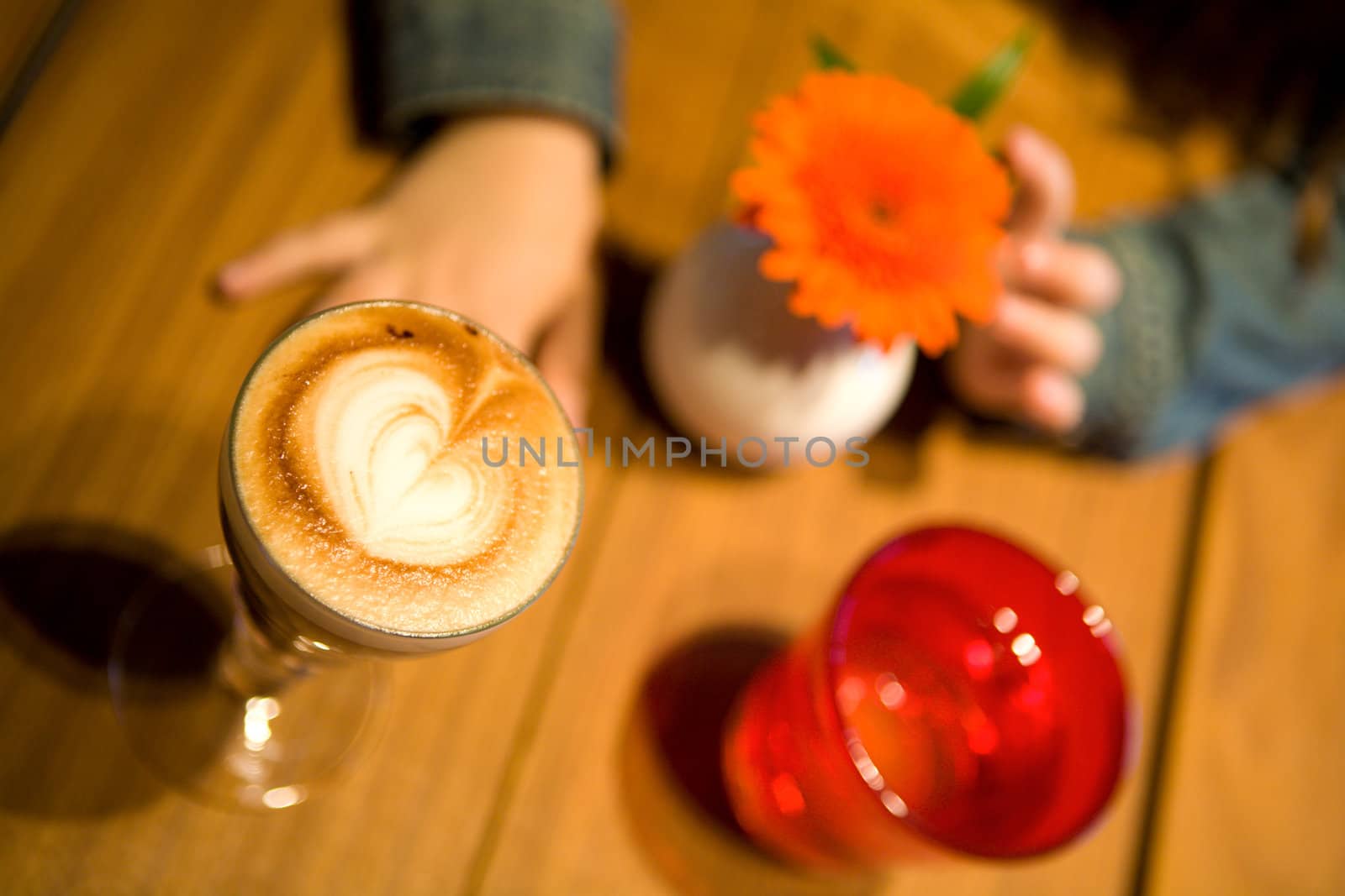 Cafe Table close-up with flower and hands