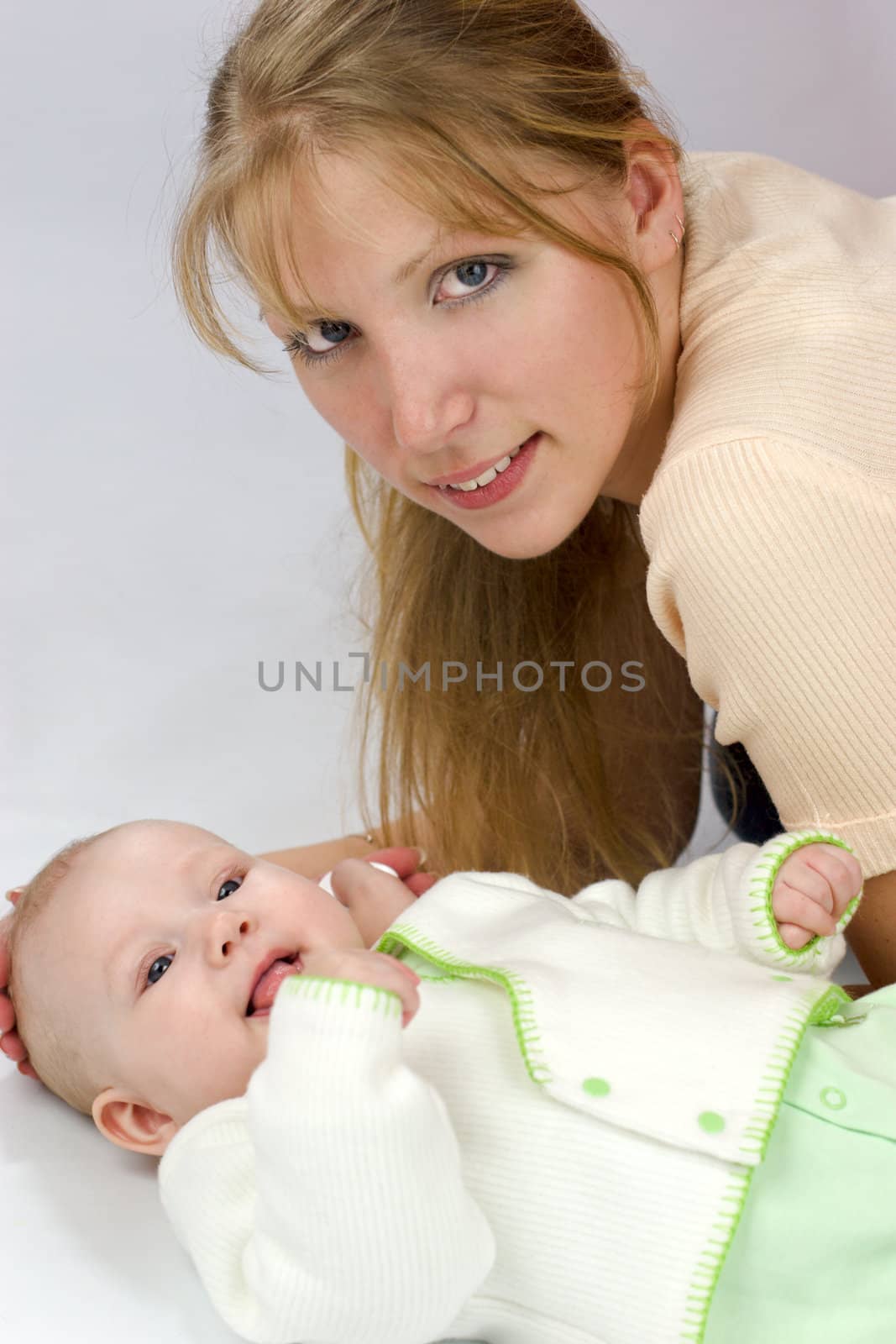 Mother with six month baby looking at you