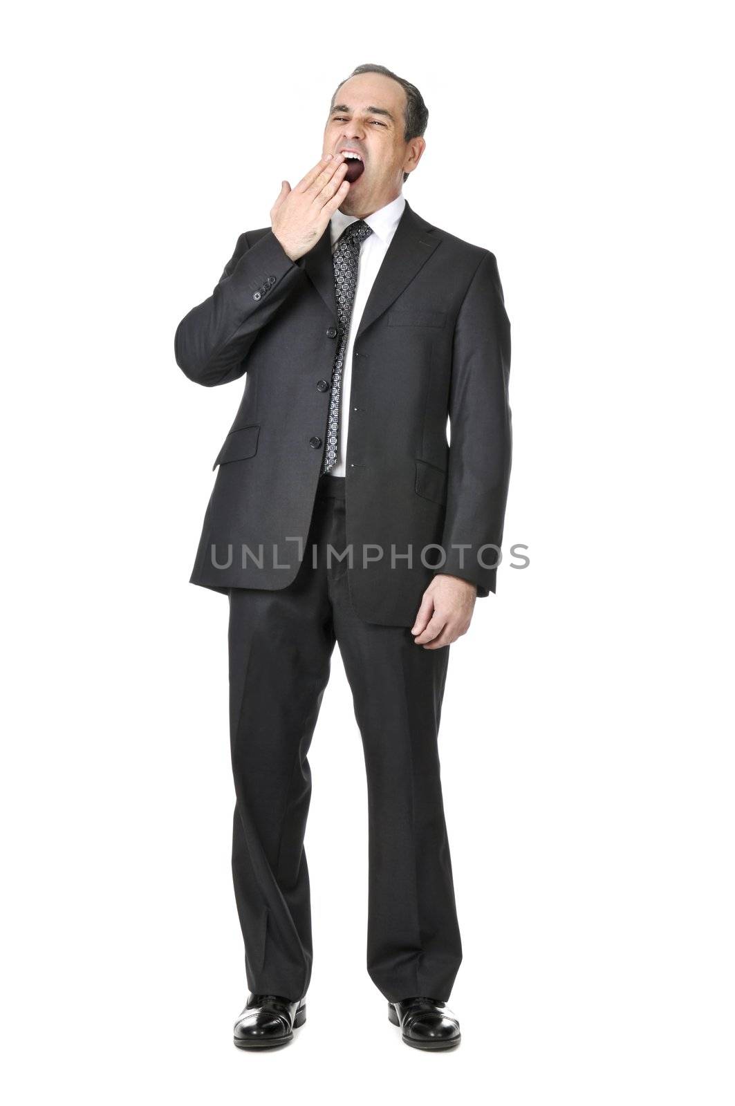 Bored yawning businessman in a suit isolated on white background