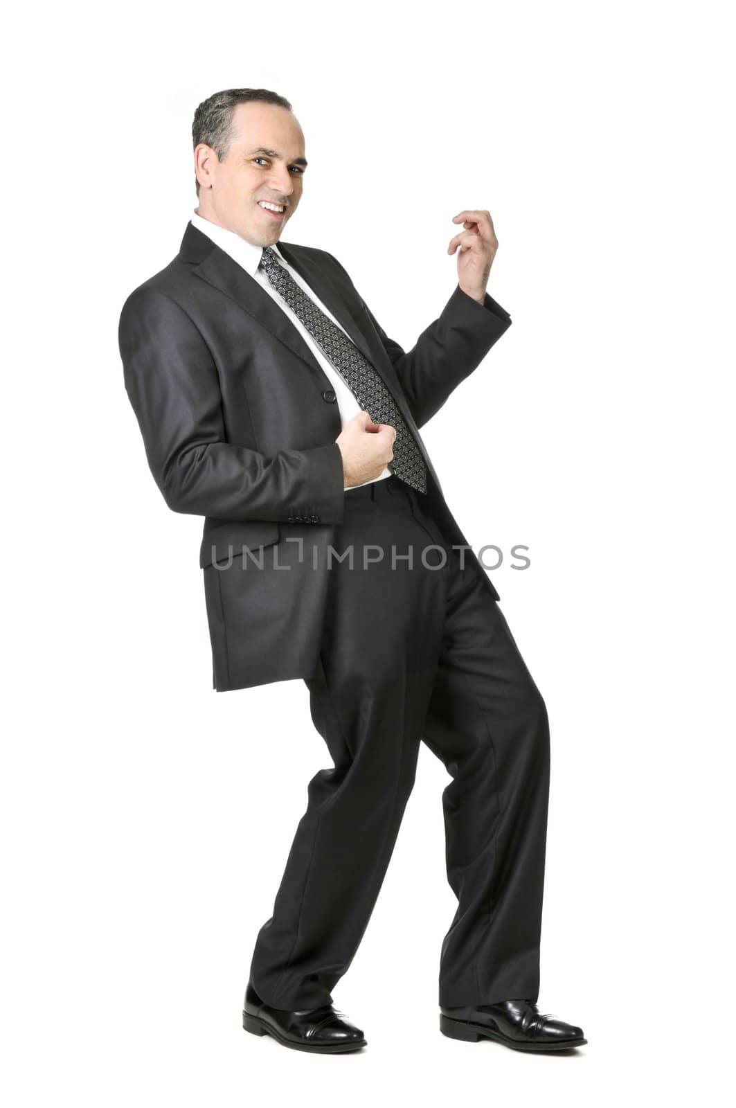 Happy businessman in a suit playing an air guitar isolated on white background