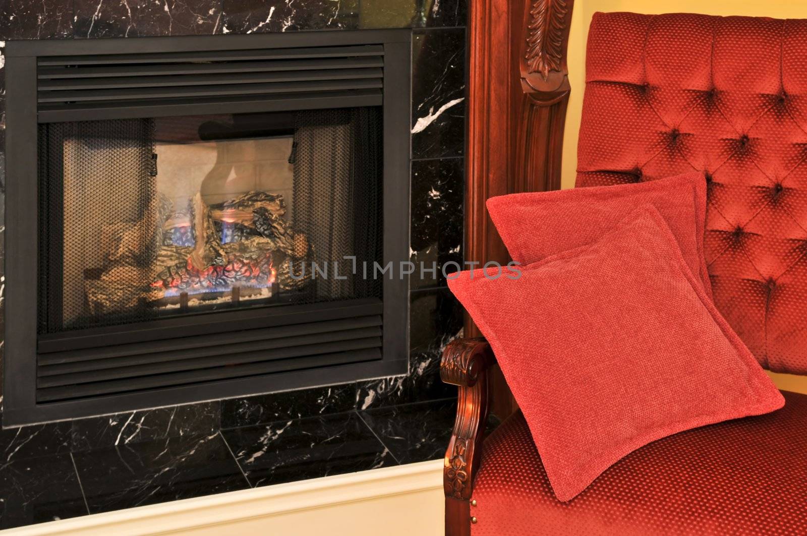 Fireplace and red chair in living room