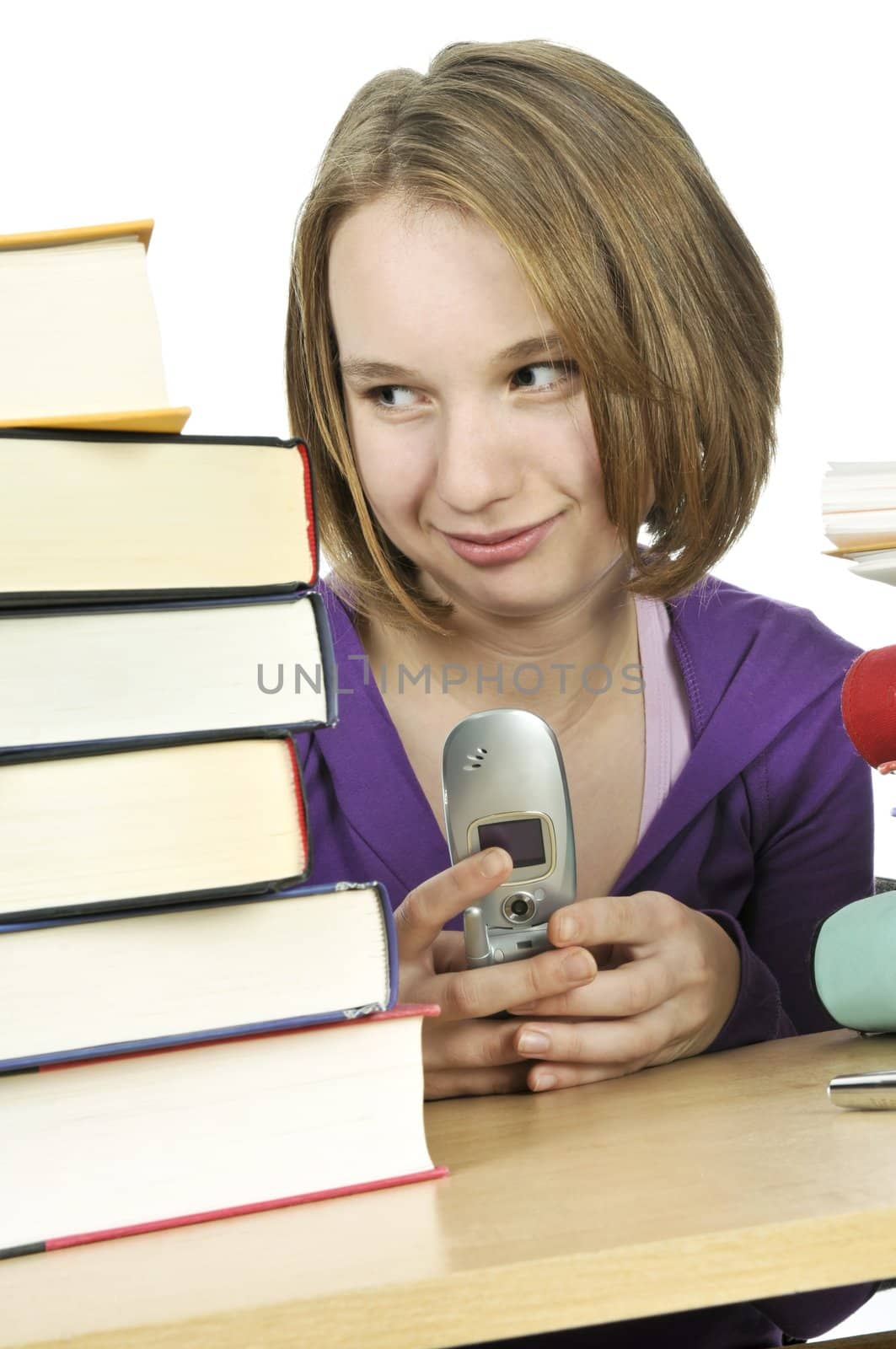 Teenage girl text messaging with cell phone in school