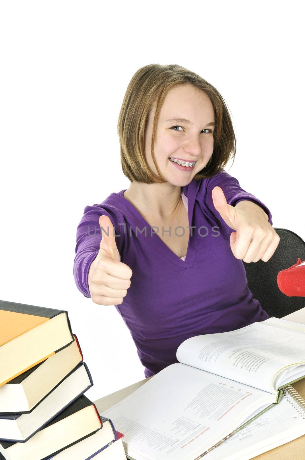 Happy teenage girl studying at the desk