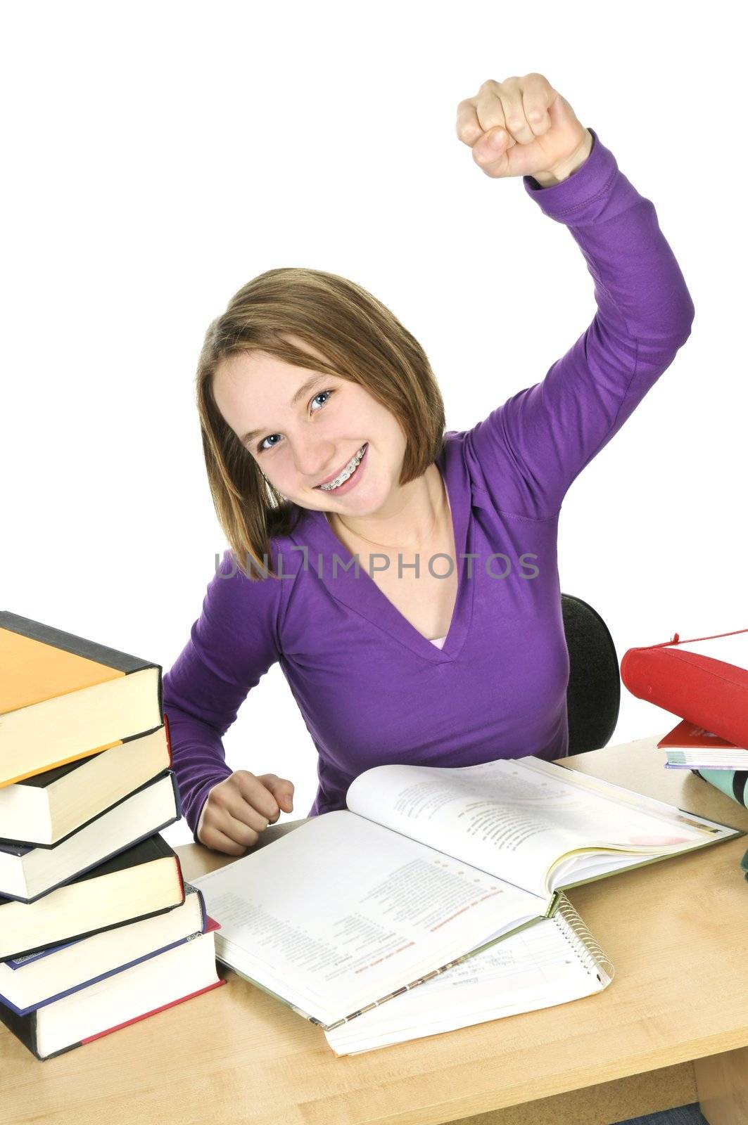 Happy teenage girl studying at the desk