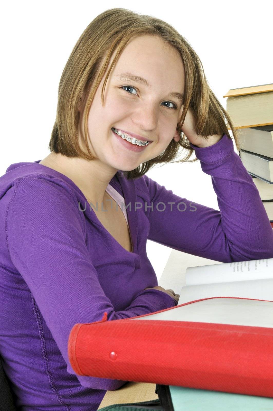 Happy teenage girl studying at the desk