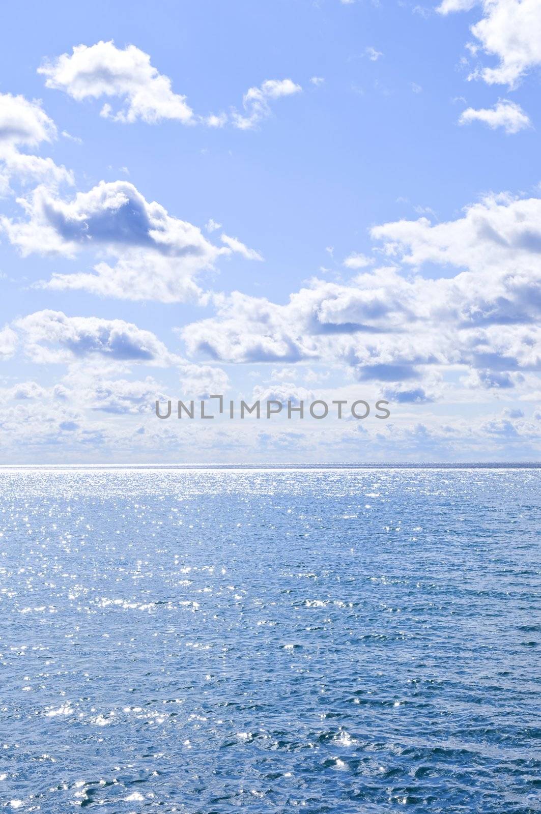 Blue ocean water and sunny sky background