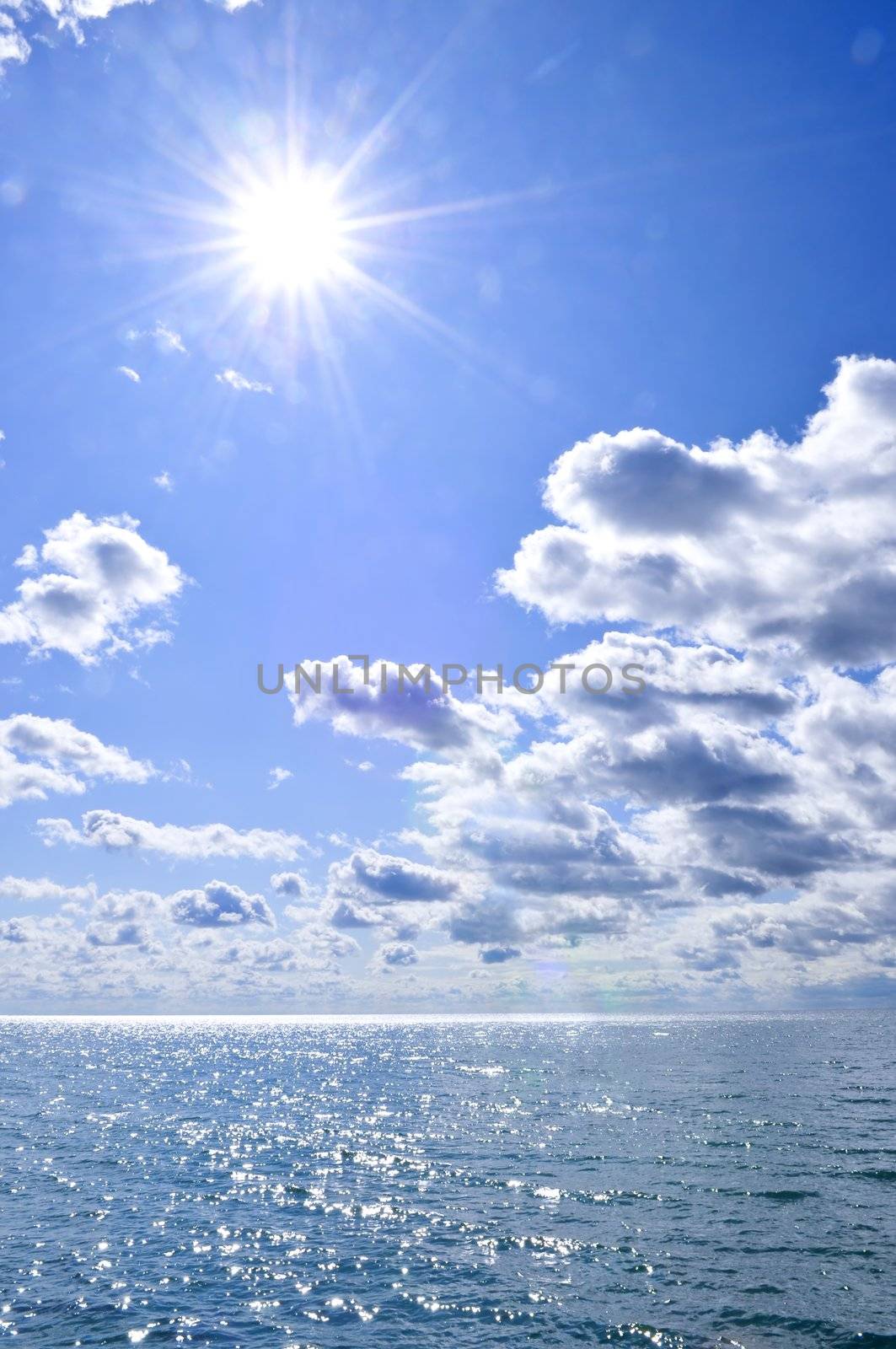Blue ocean water and sunny sky background