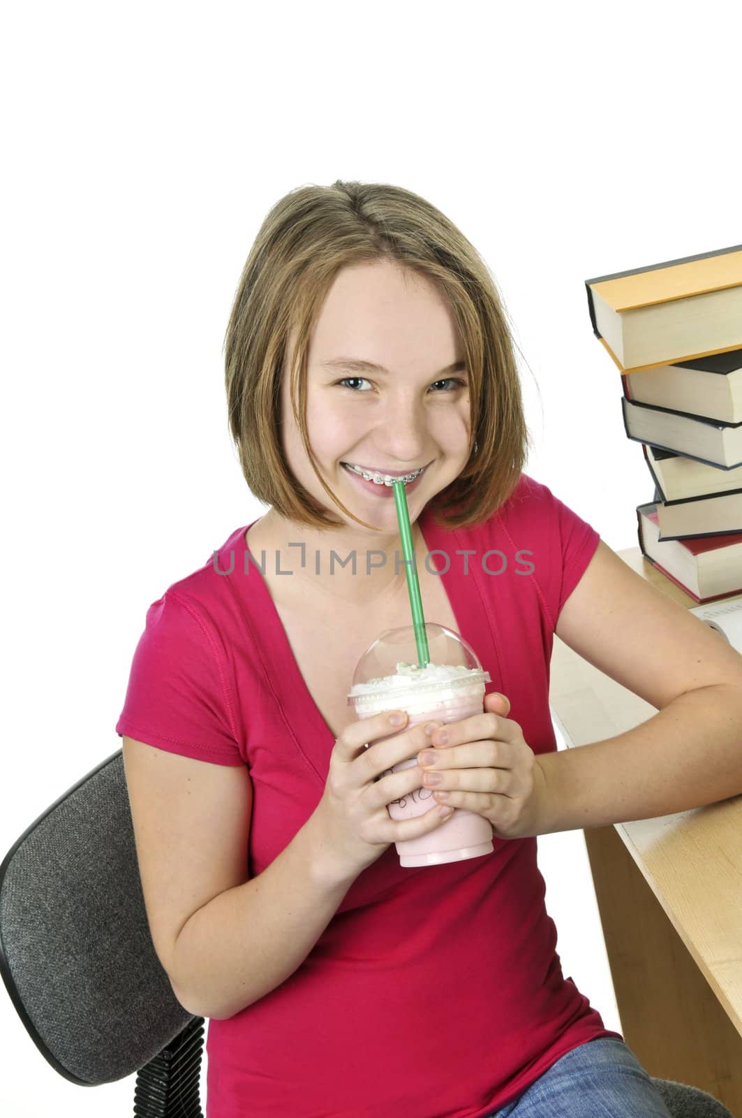 Teenage girl holding a cup with milkshake