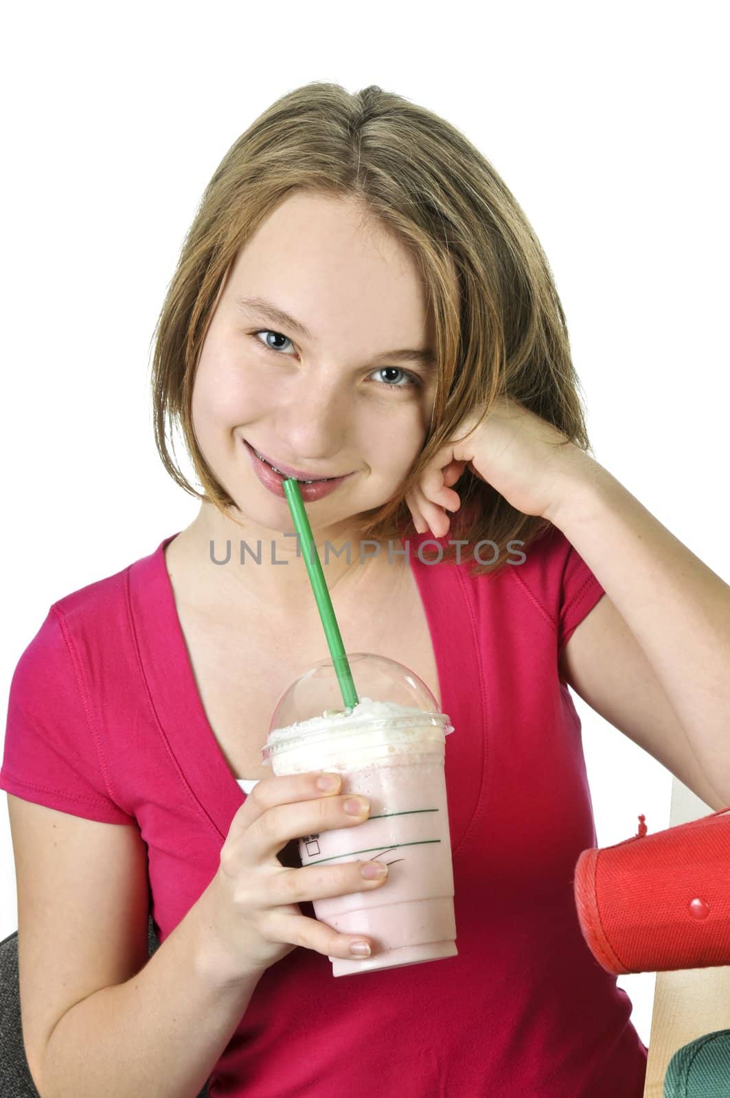 Teenage girl holding a cup with milkshake