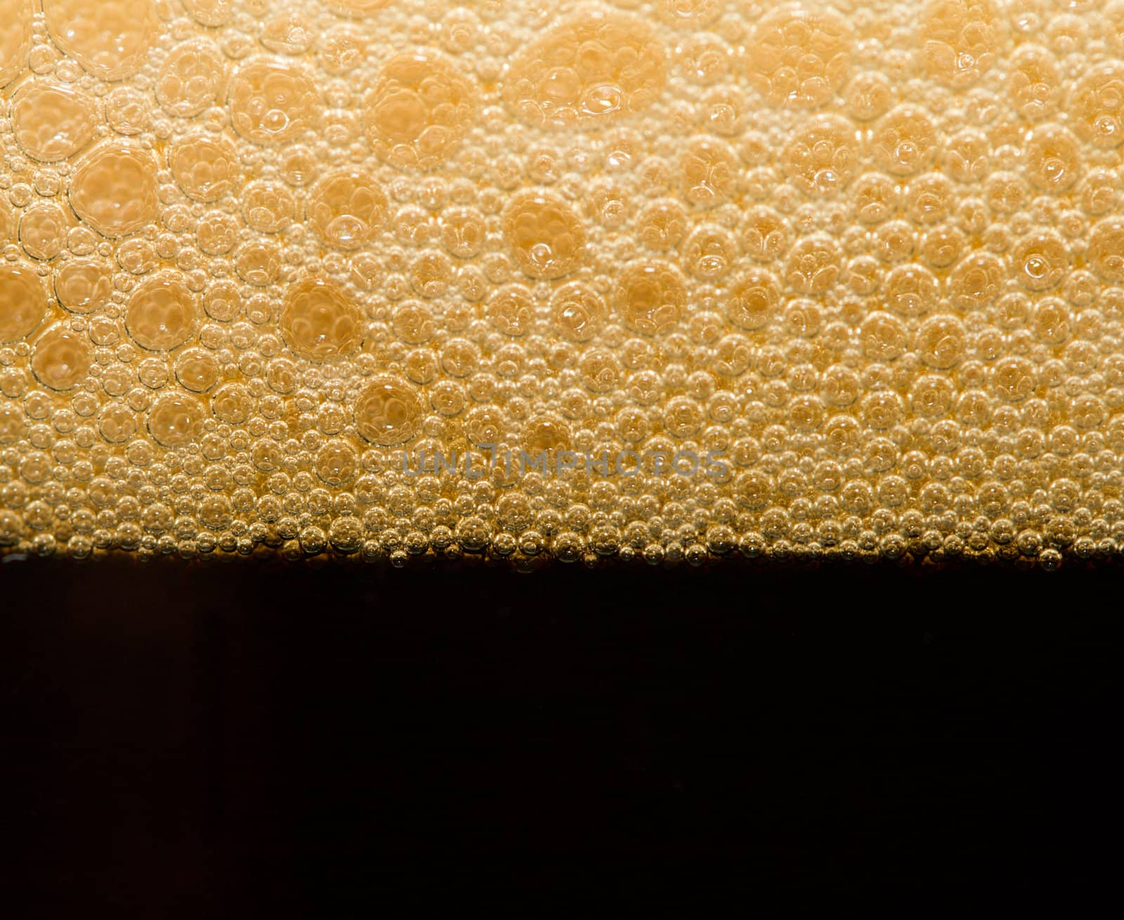 foam from dark beer with bubbles by Alekcey