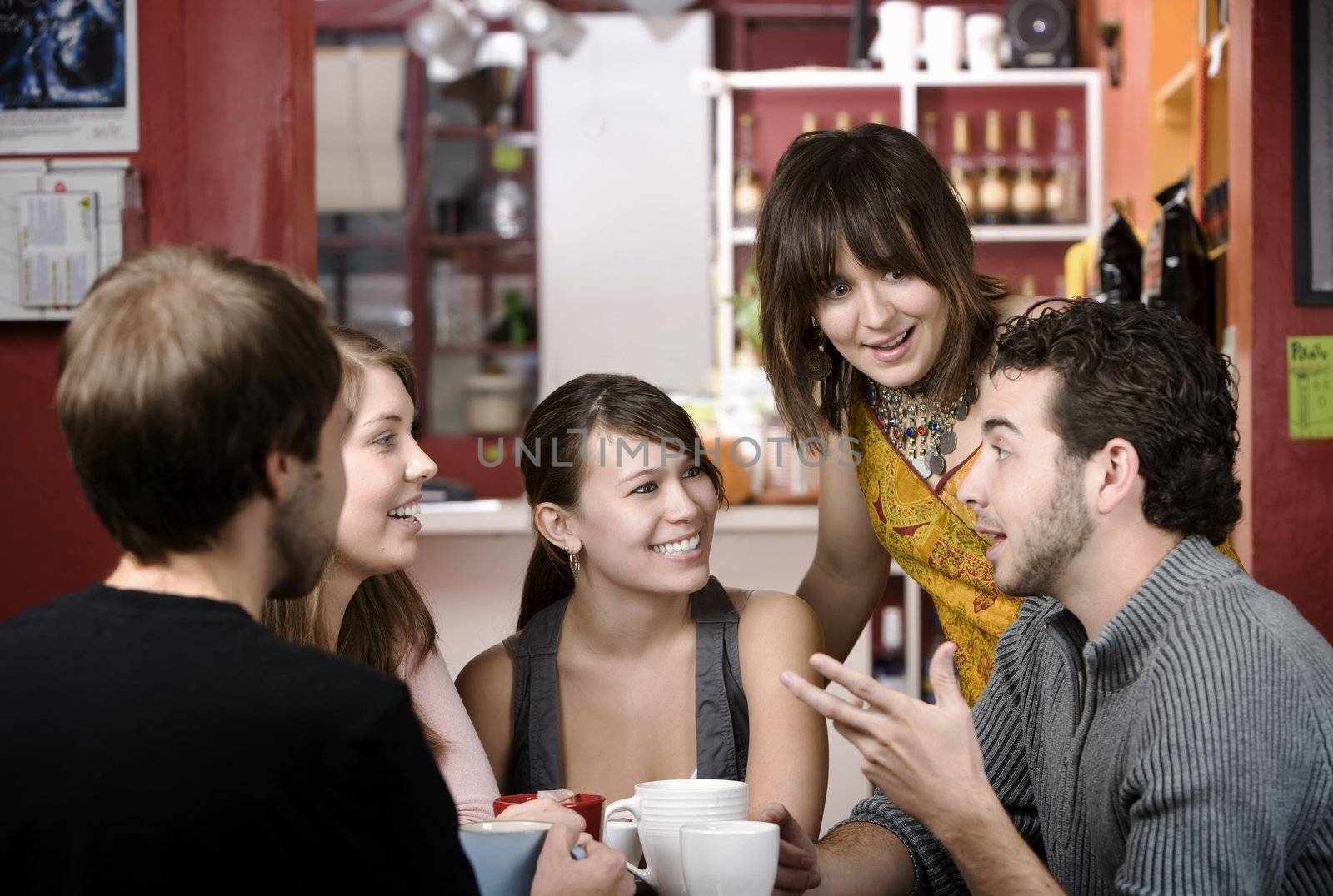 Five young friends in a coffee house