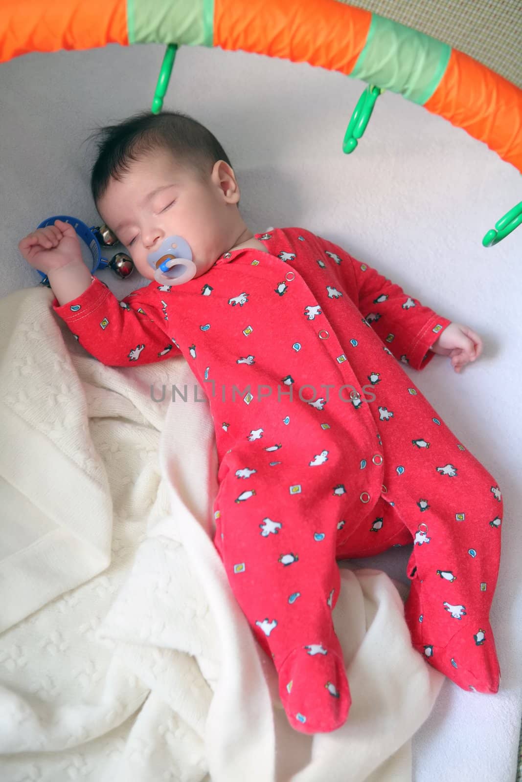 infant in red cloth sweetly sleeps