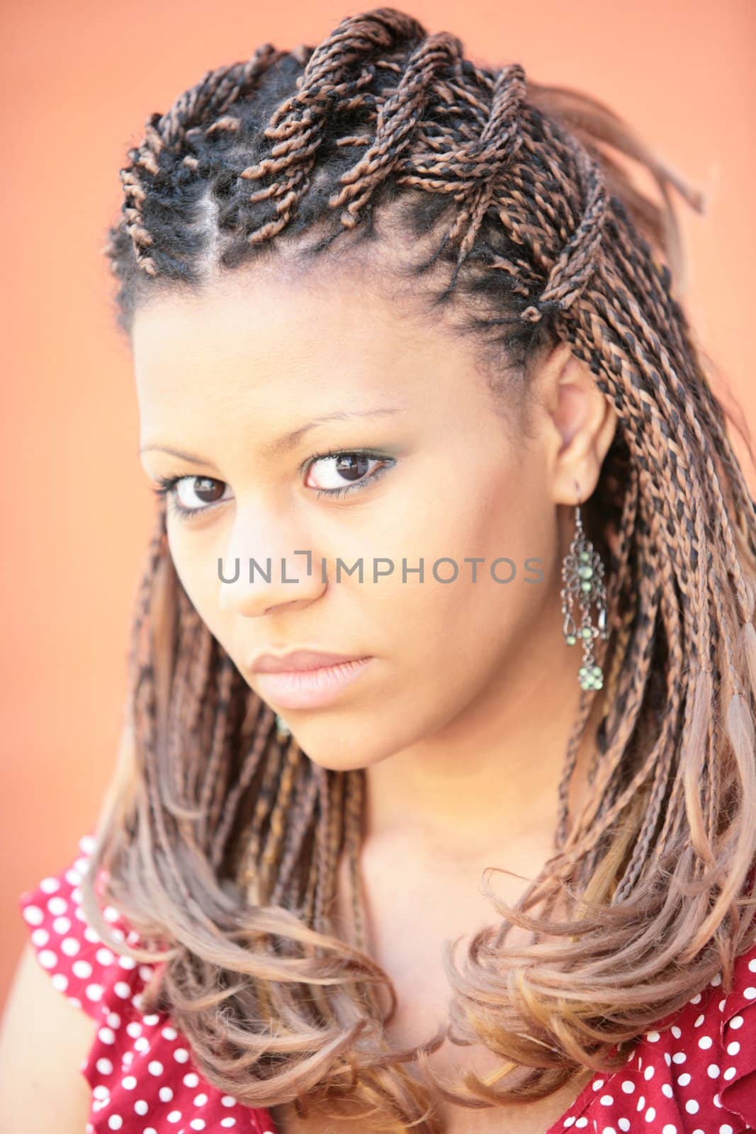 beautiful black girl with exotic hairstyle on red background