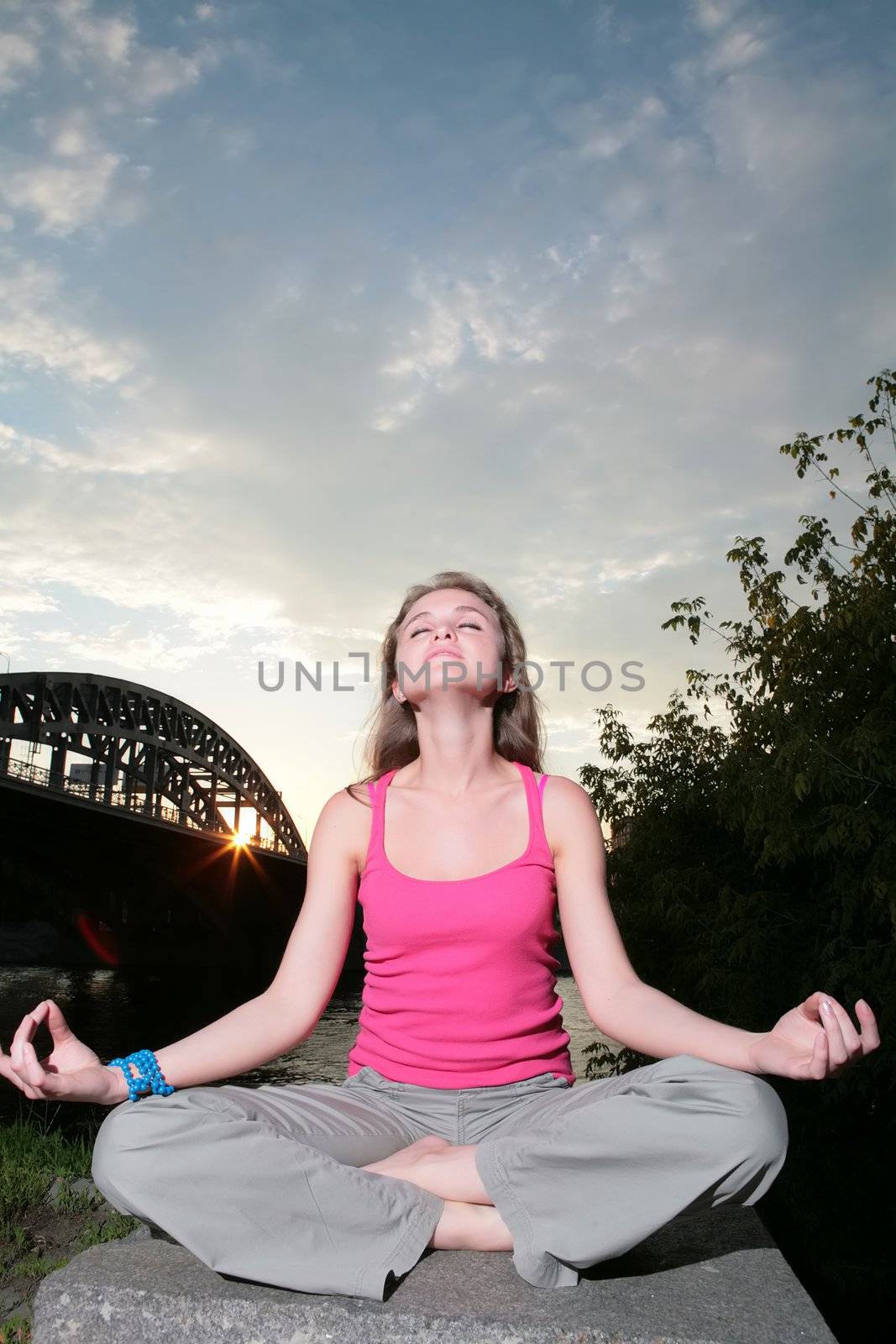 session of evening relaxation on background of the sky and silhouette of the bridge