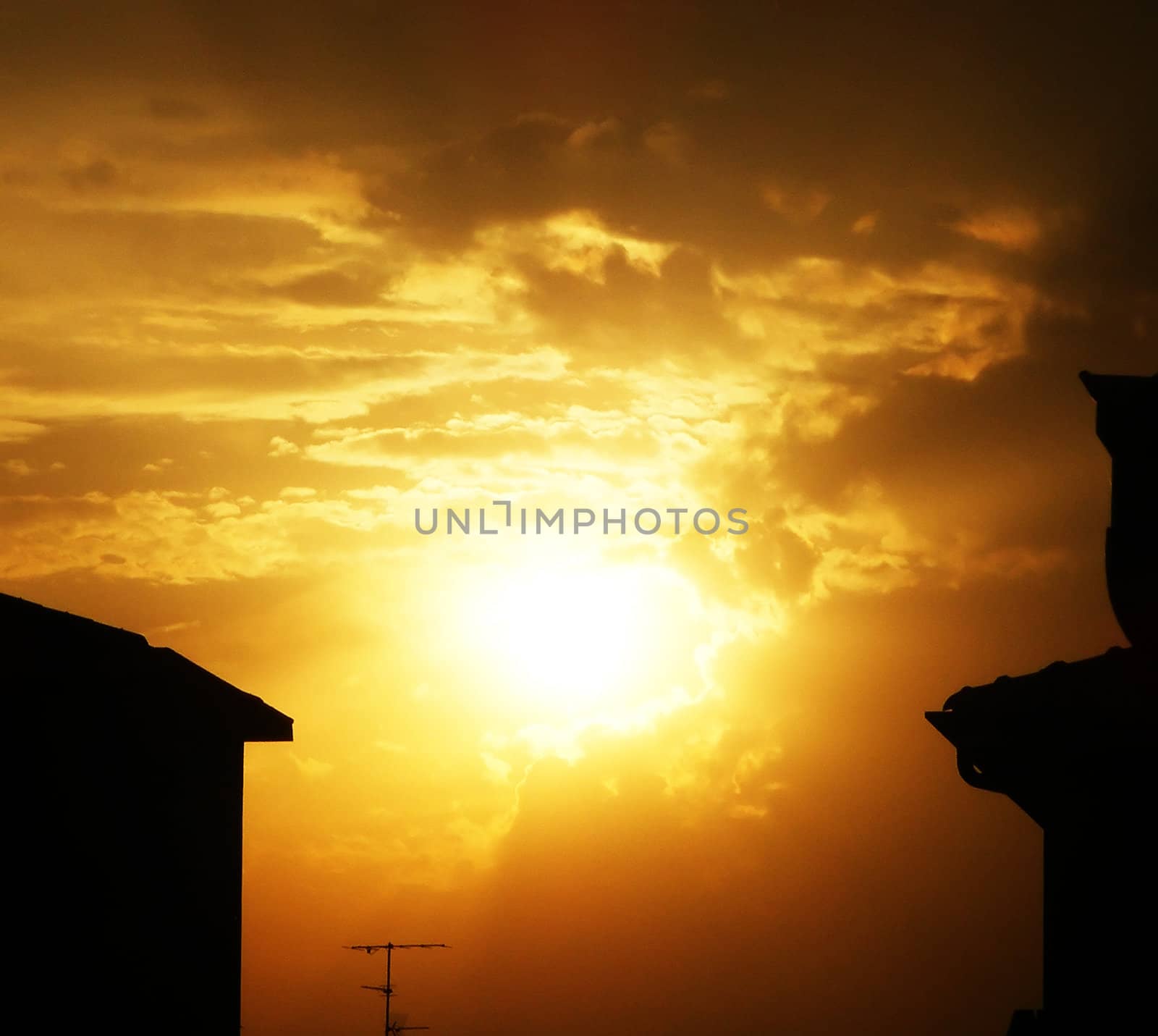 A yellow and orange sunset between the buildings