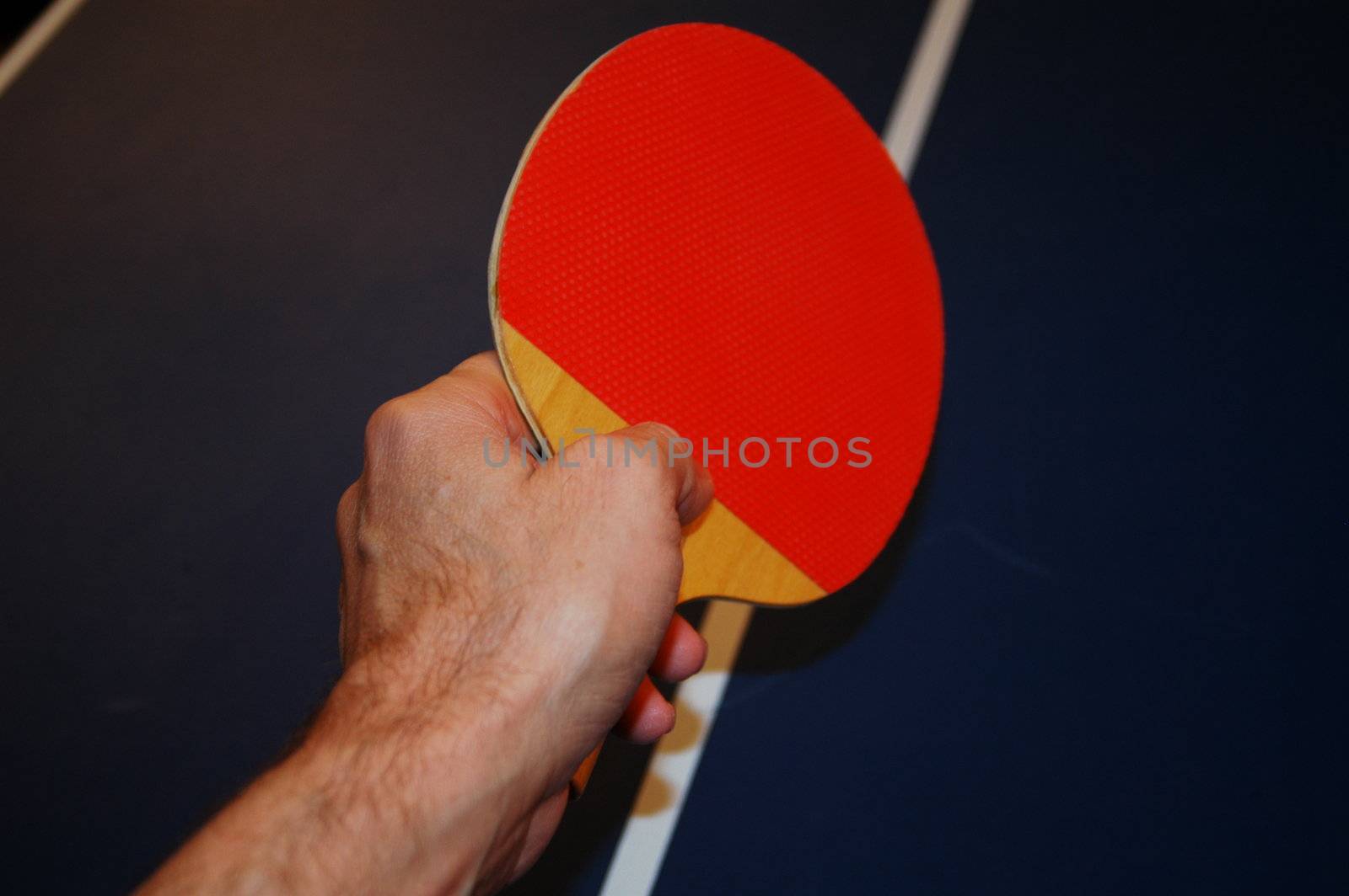 Ping pong game, a hand ready to strike the ball