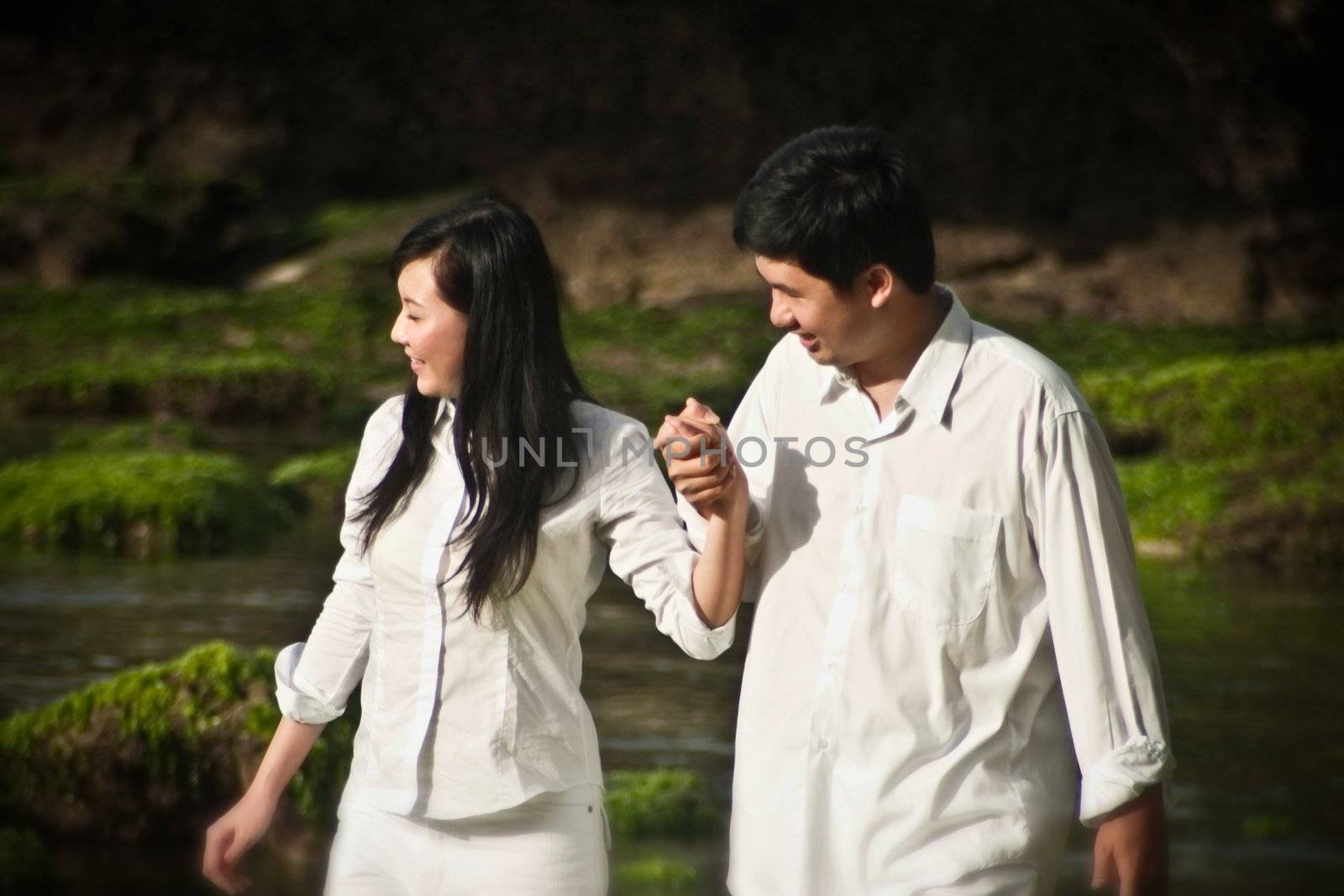 Young couple walking and holding hands