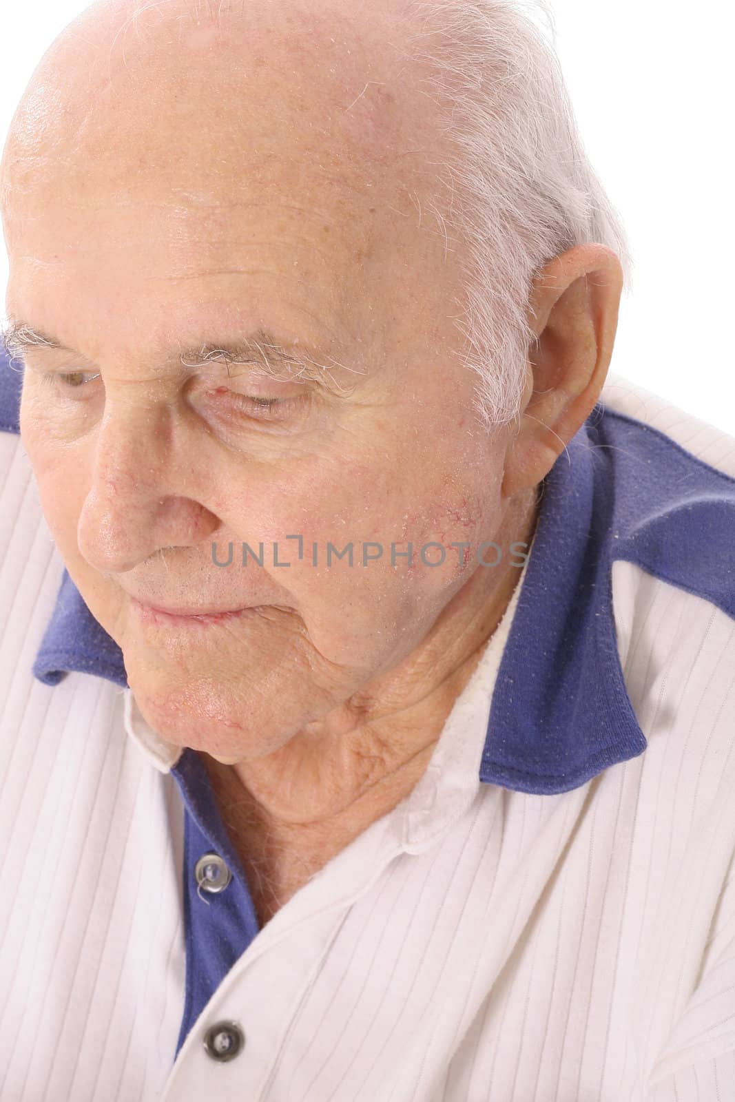 shot of an elderly man looking down depressed by creativestock