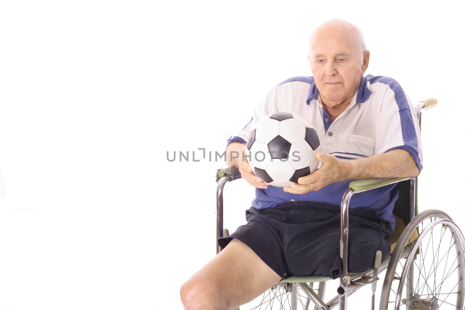 shot of a handicap elderly man with soccer ball by creativestock