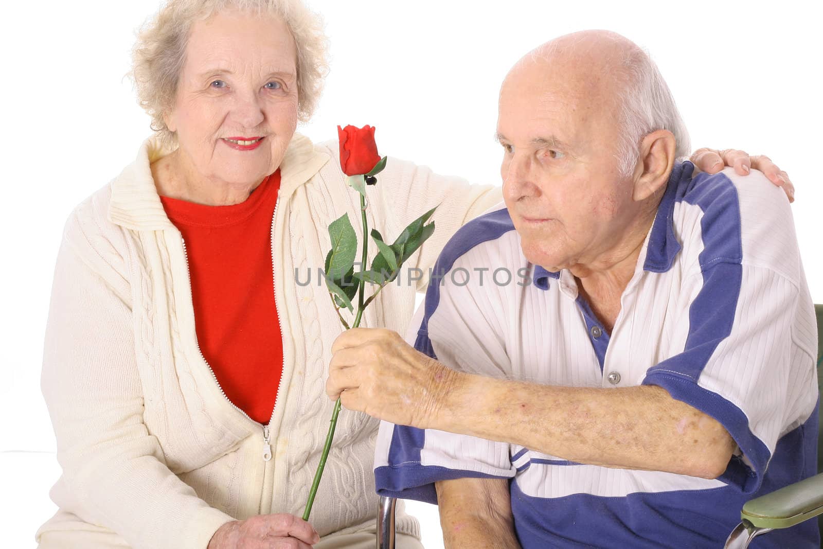 shot of a handicap man giving his wife a rose by creativestock