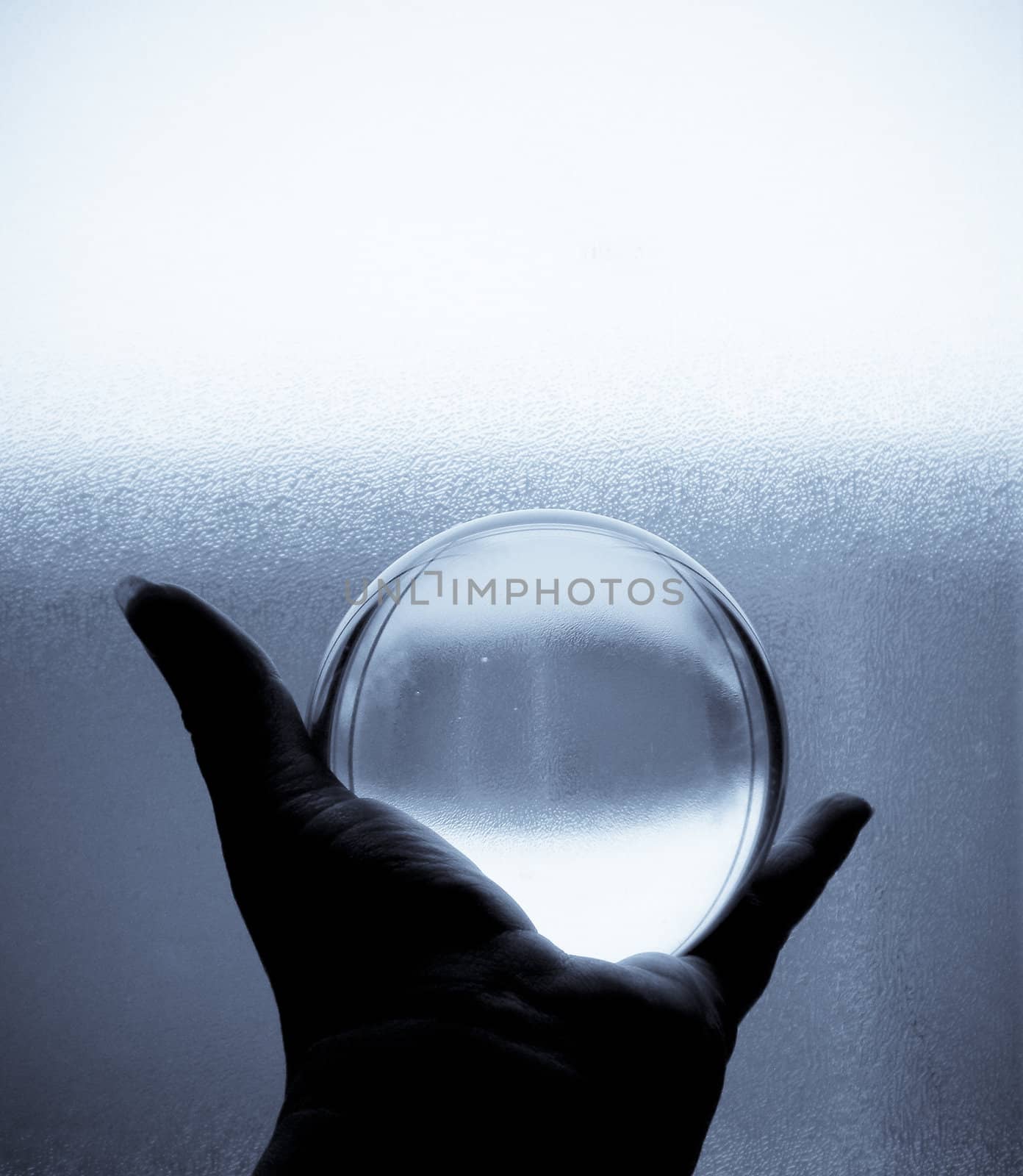 Crystal ball being held in hand in black and white