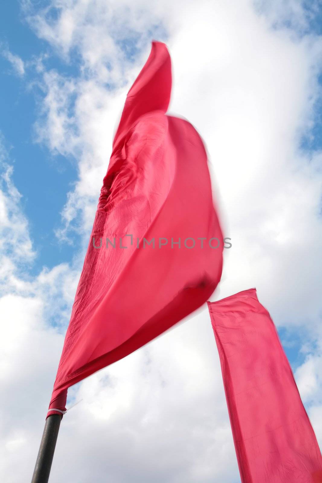 festive red flags on winds and blue sky