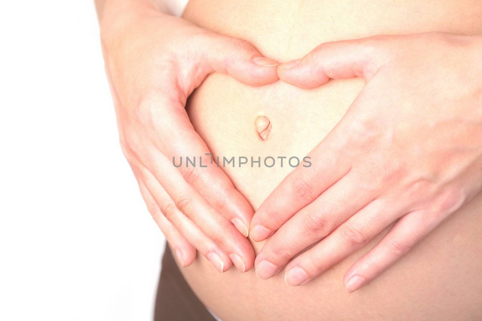 belly and hands of the pregnant woman on white background