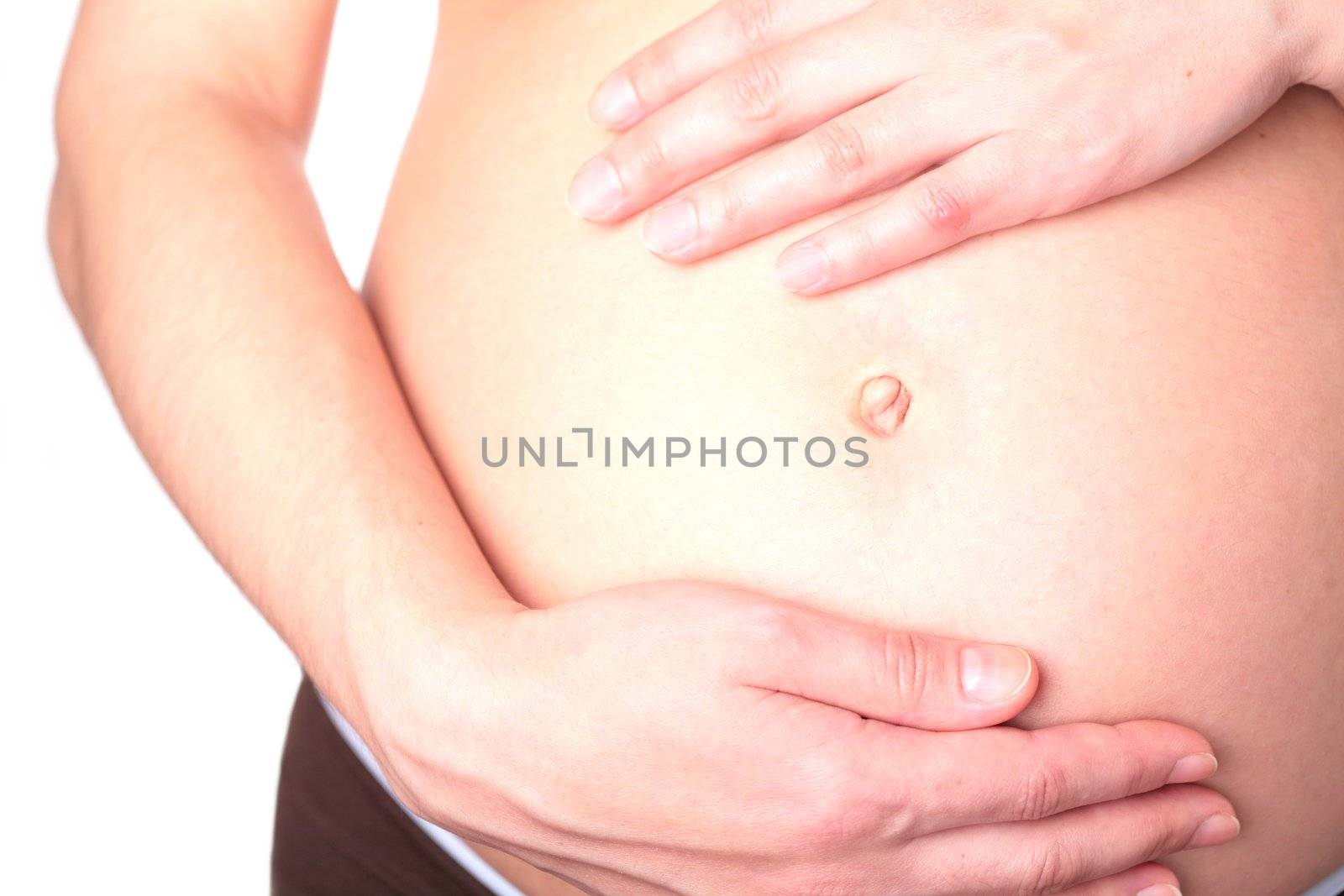 pregnant woman touching her belly with hands