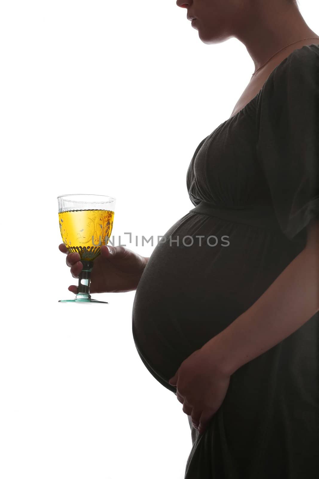 silhouette of the pregnant woman with juice in luxurious goblet on white background