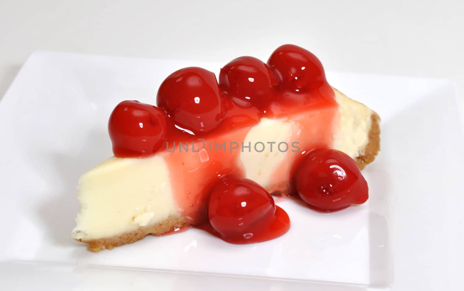 Cherry cheesecake isolated on white background.