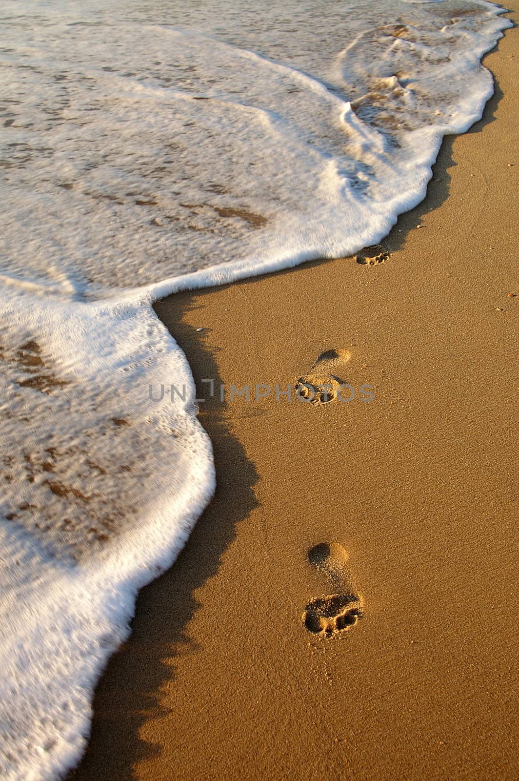 fading footprint on the beach by Maya