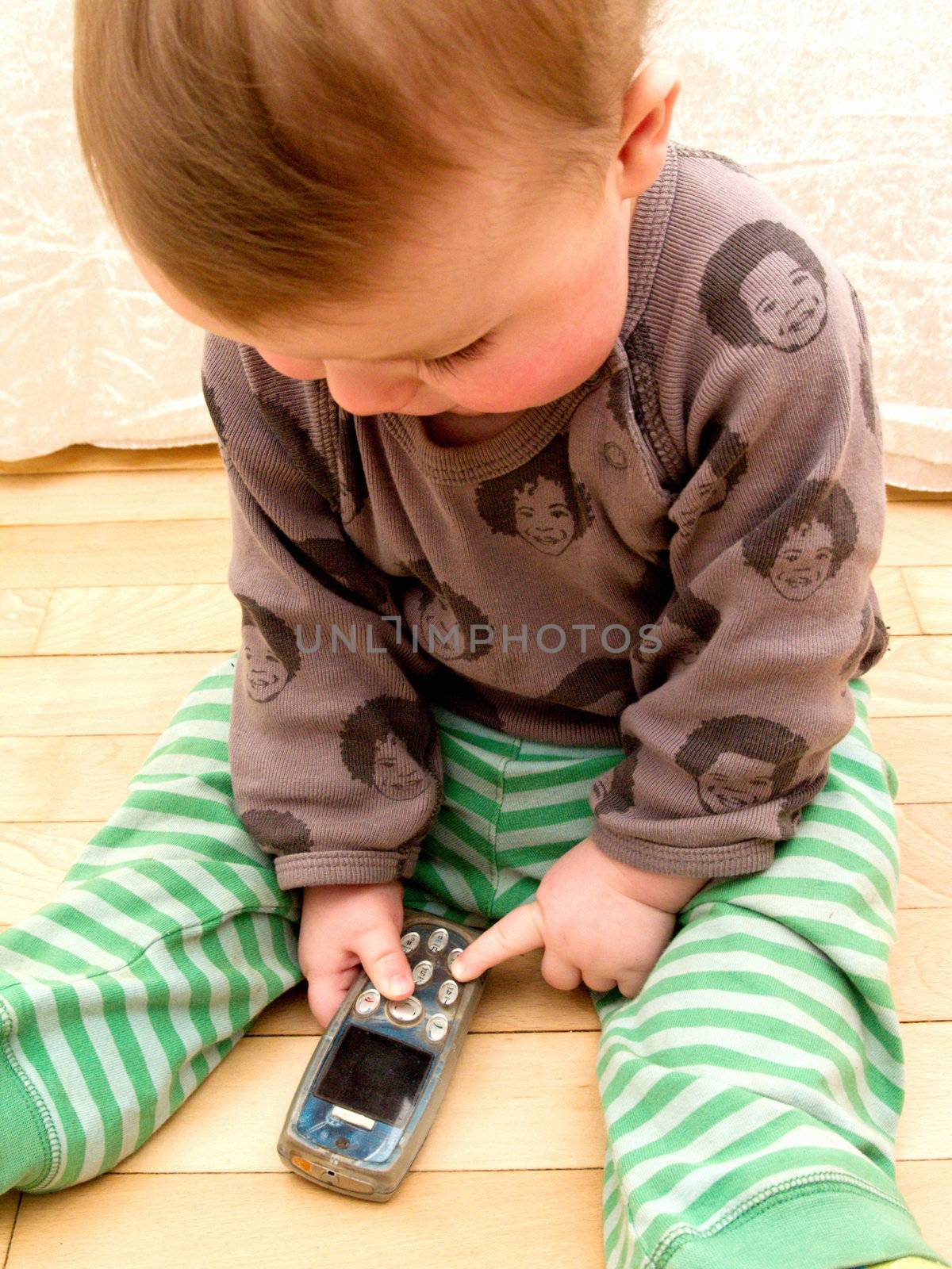 Portrait of baby boy using cell phone