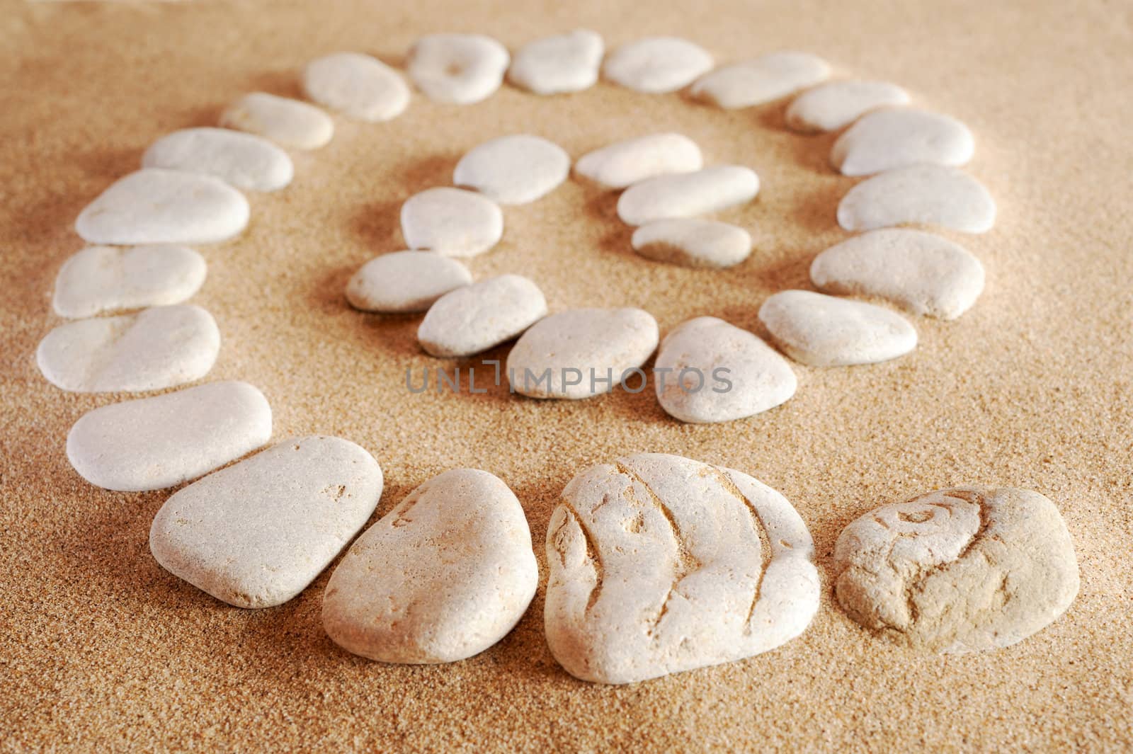 Spiral from sea stones on sand at the sea