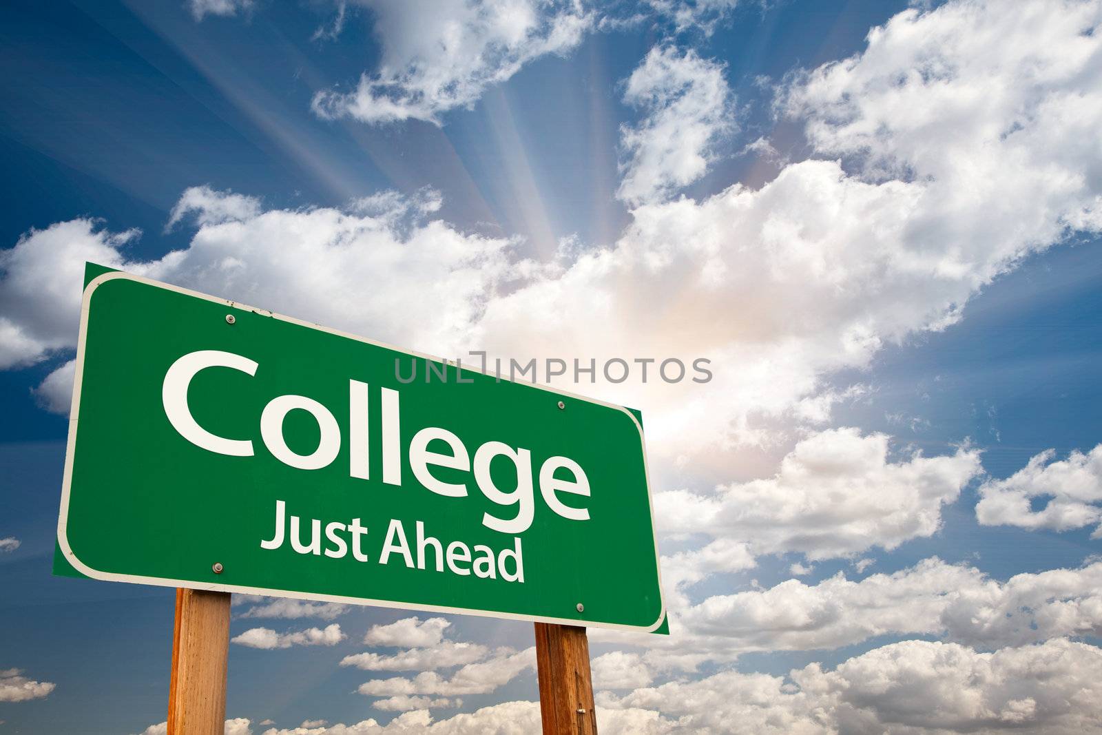 College Just Ahead Green Road Sign with Dramatic Clouds, Sun Rays and Sky.