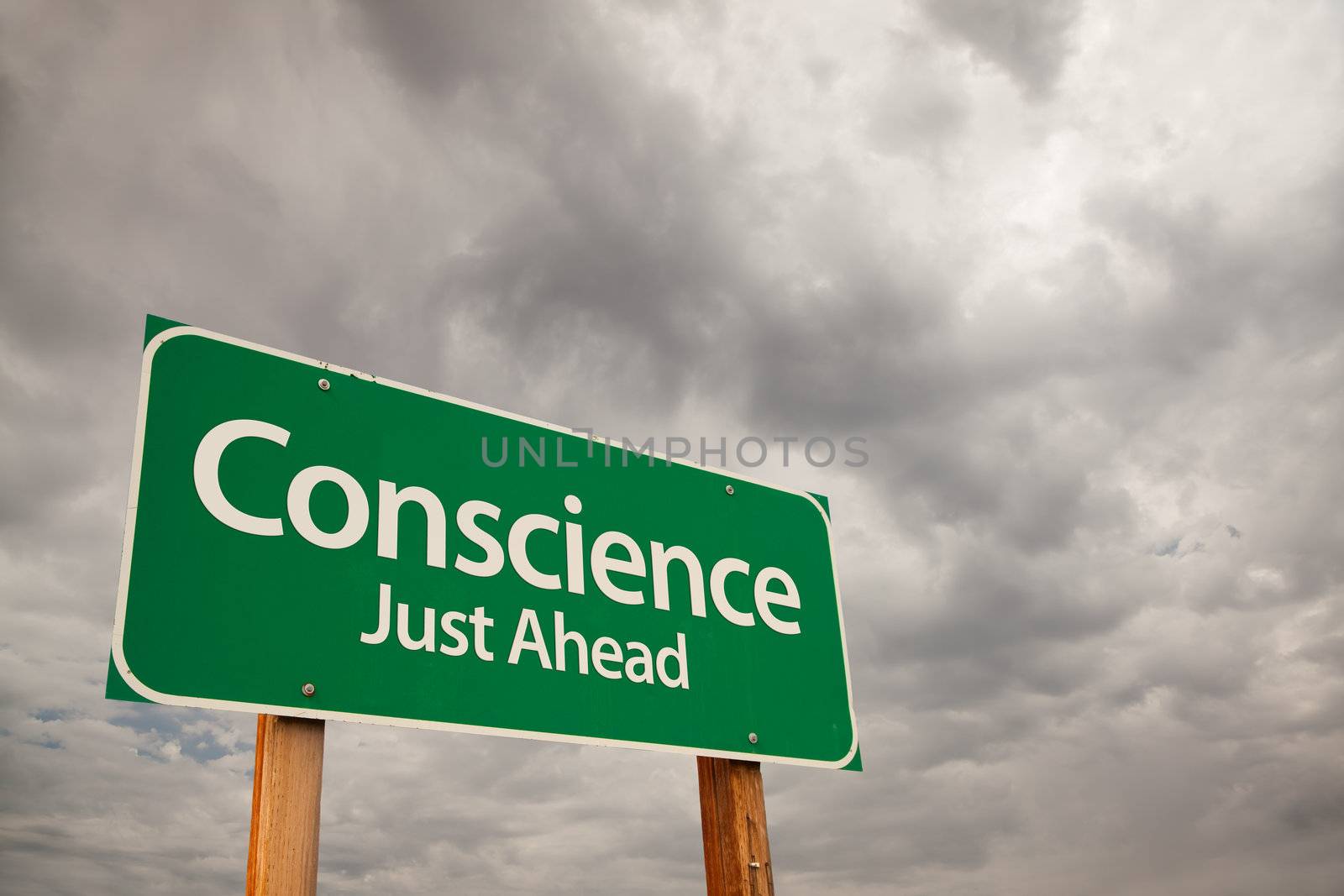 Conscience Just Ahead Green Road Sign with Dramatic Storm Clouds and Sky.