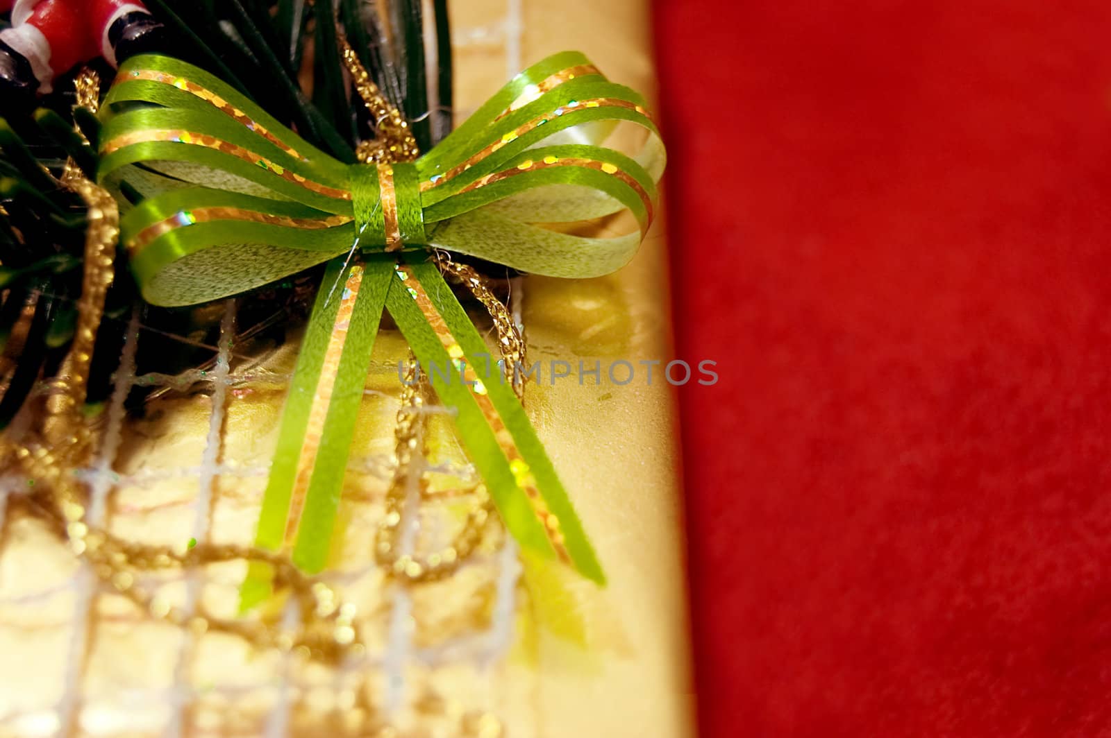 gift box with bow over holiday lights background