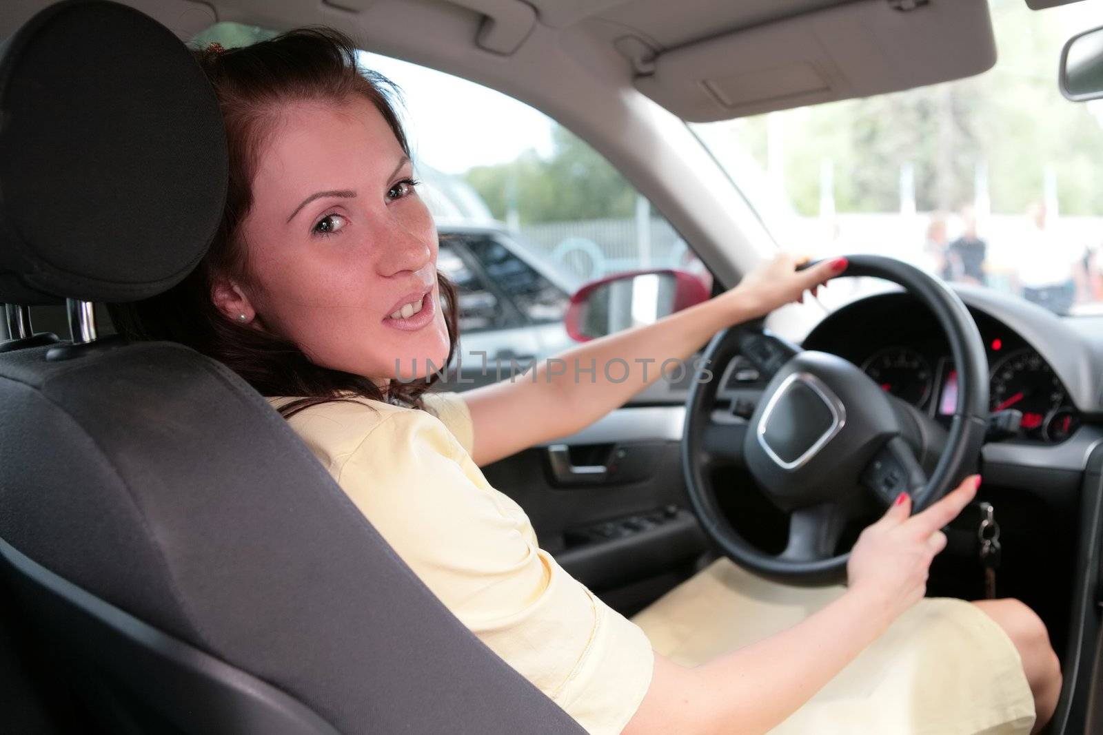 girl in car keeps steering wheel