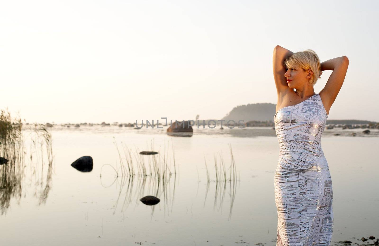 pretty blond in fancy dress at the seashore