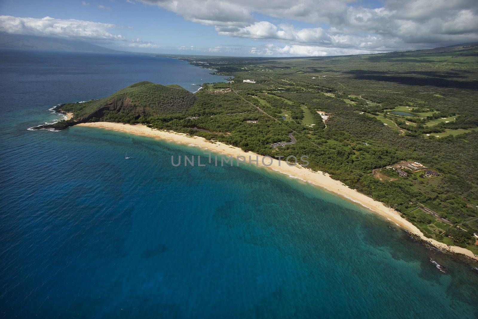 Aerial of coastline with sandy beach and Pacific ocean in Maui, Hawaii.