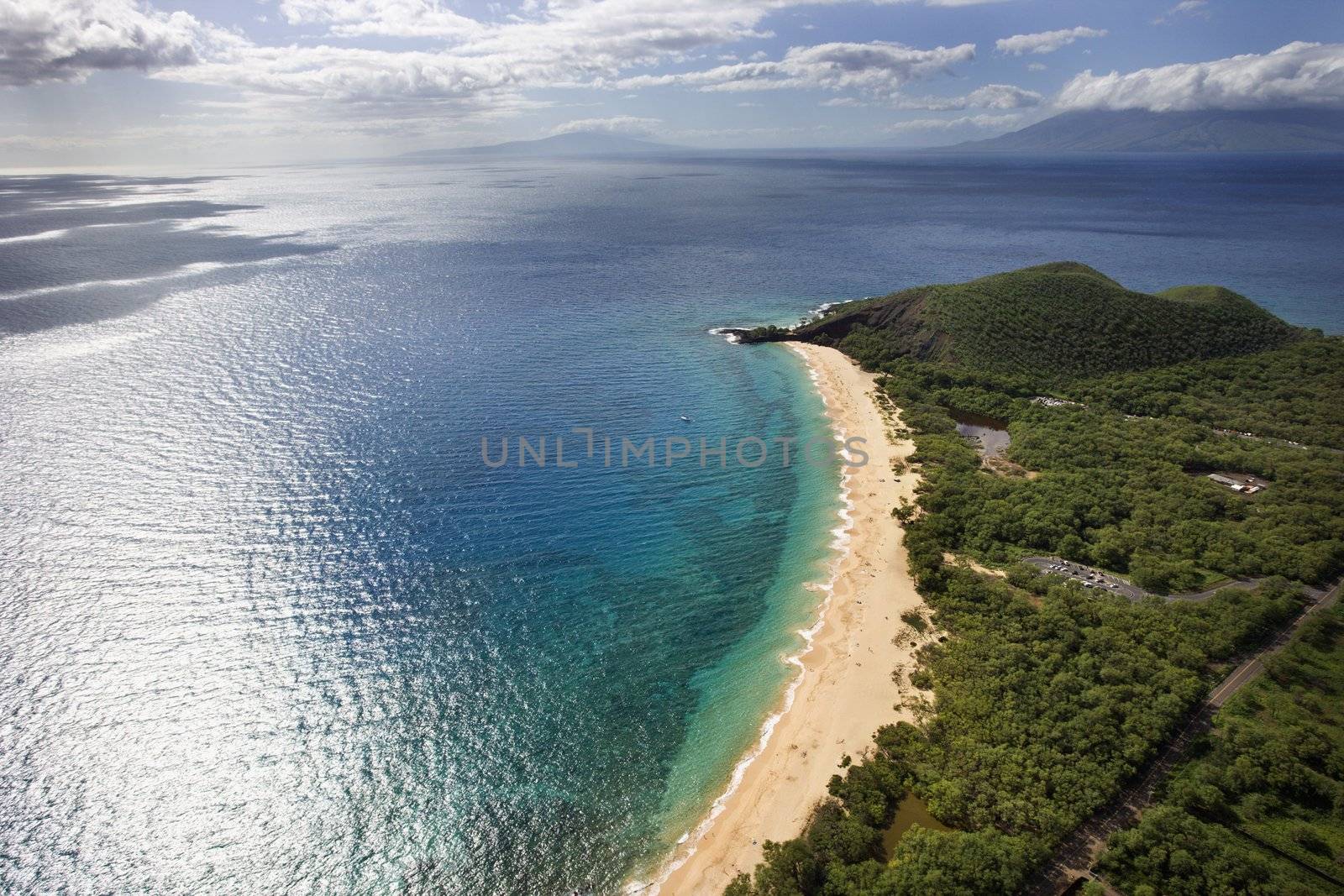 Aerial of coastline with sandy beach and Pacific ocean in Maui, Hawaii.