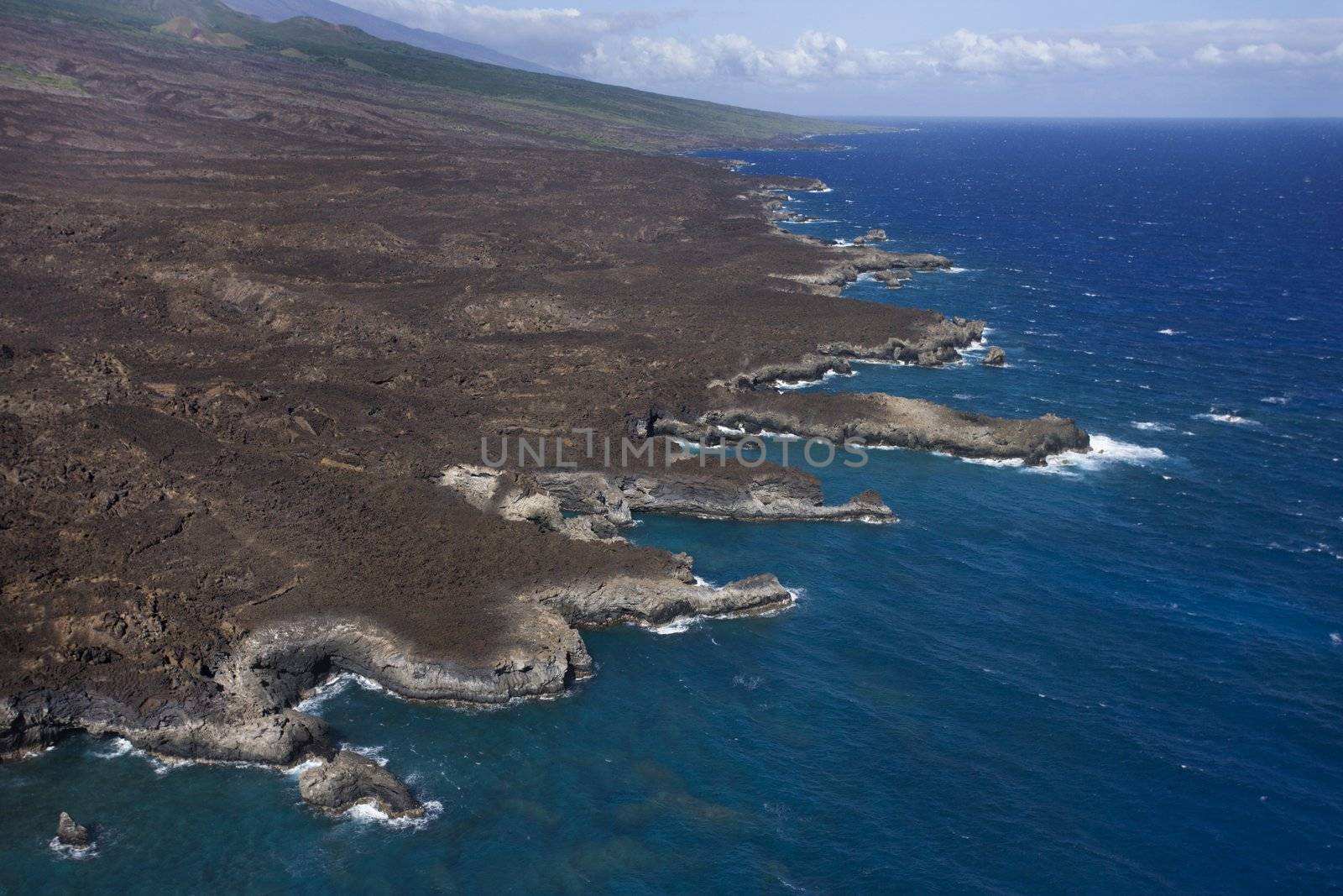 Aerial of Pacific ocean and Maui, Hawaii coast with lava rocks.