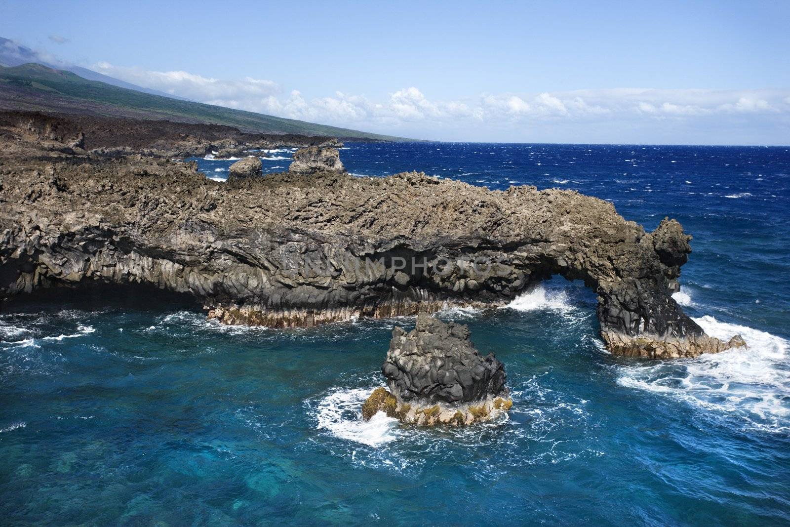 Aerial of Pacific ocean and Maui, Hawaii coast with lava rocks.