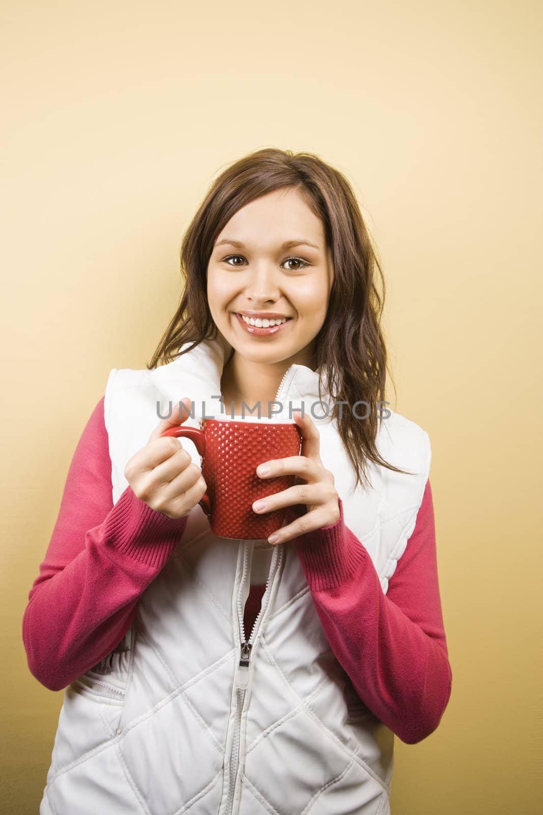 Woman holding cup. by iofoto