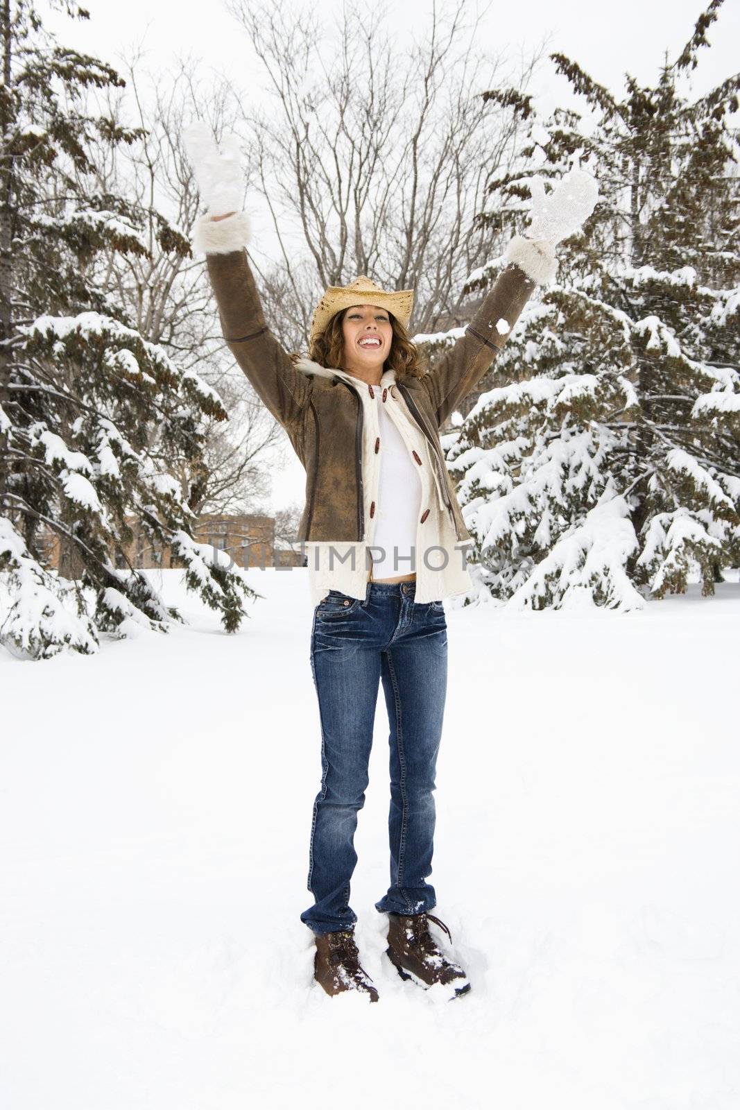 Woman with arms raised. by iofoto