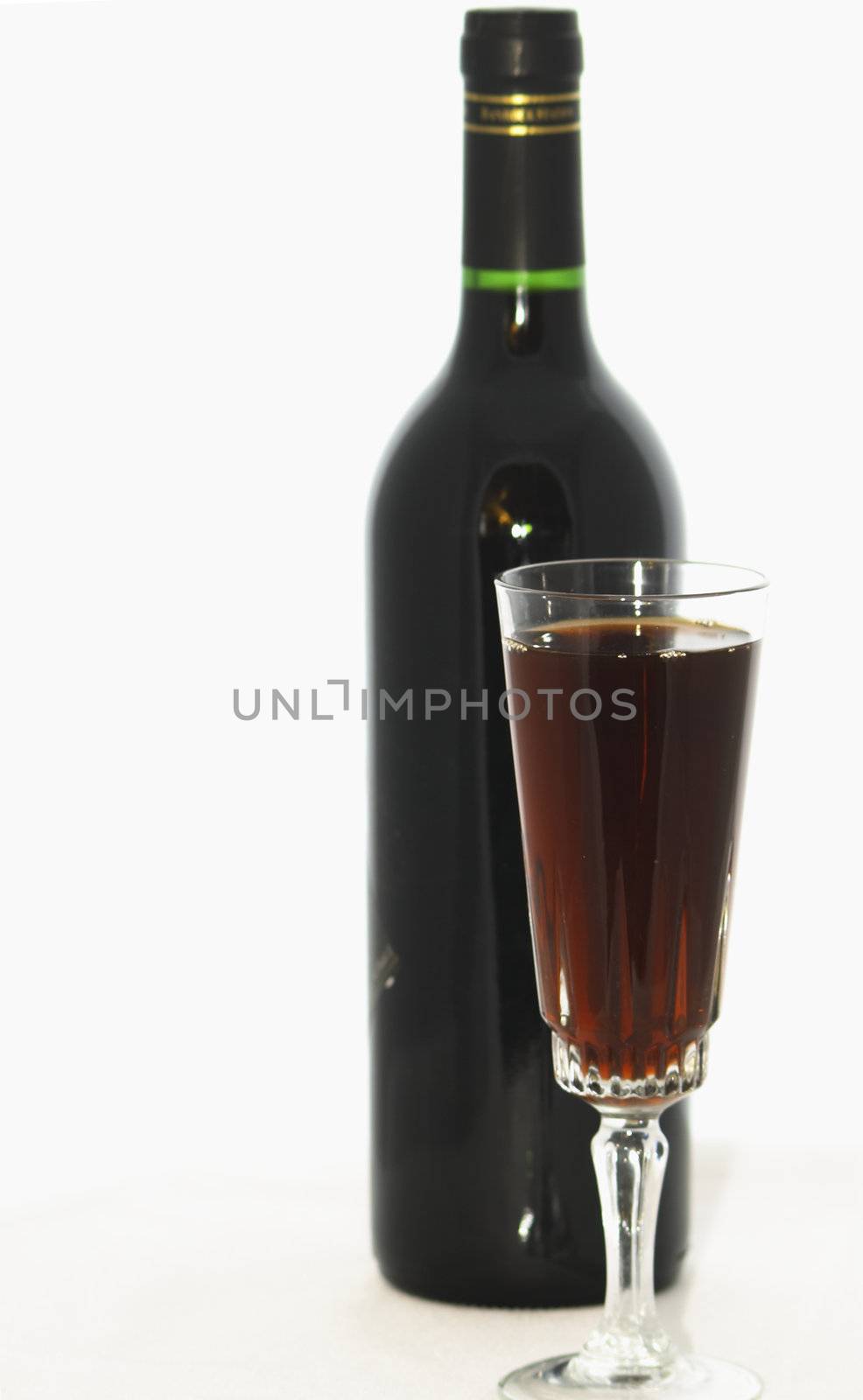 red wine and bottle by leafy
