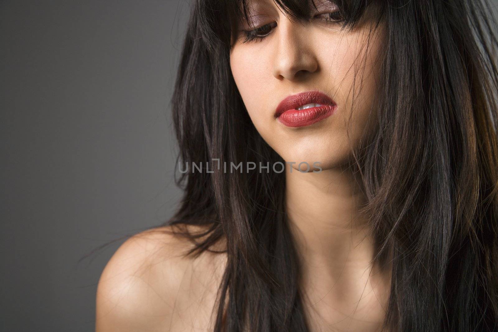 Head and shoulder portrait of pretty young woman with long black hair.